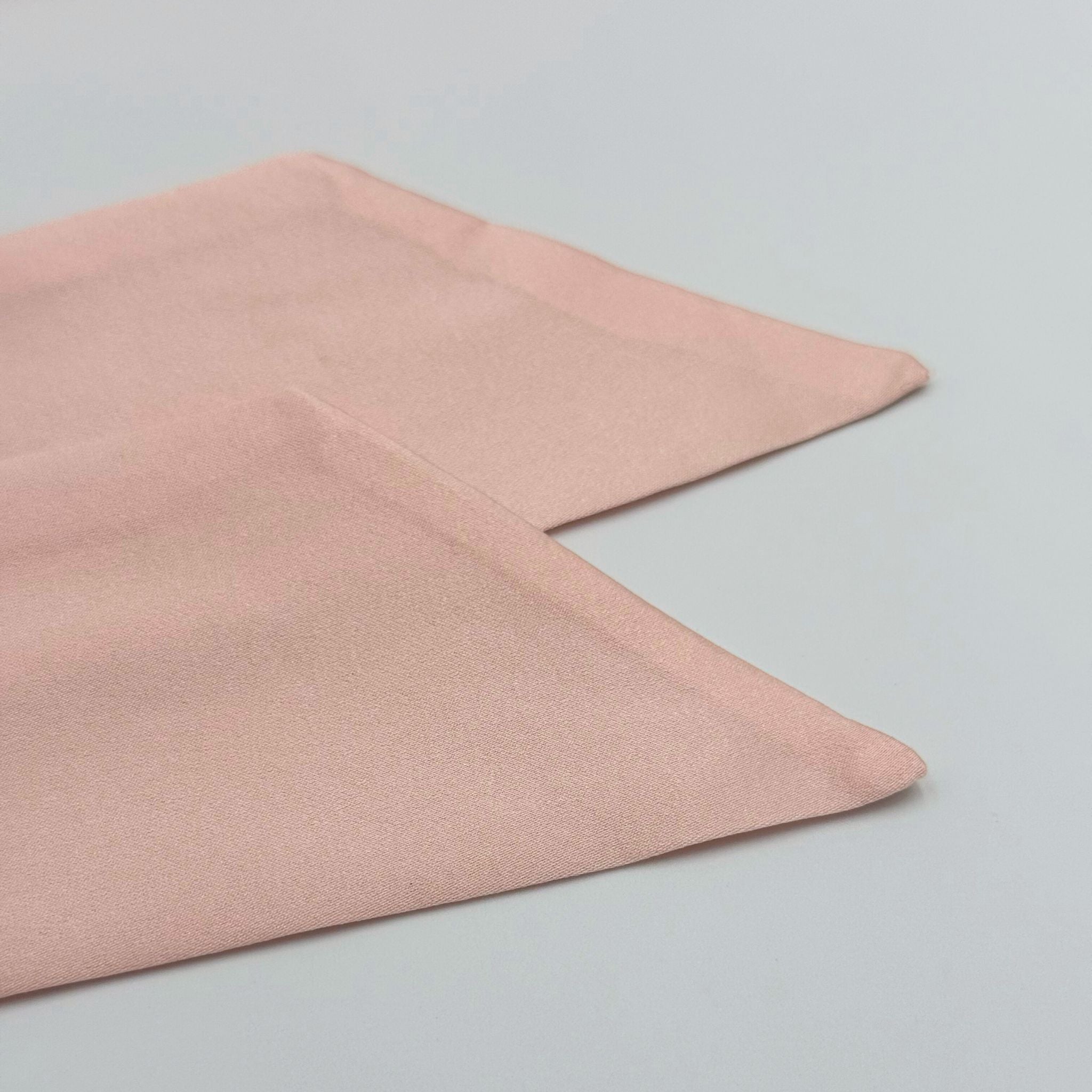 Pink silk ties for bonnet on a light gray background