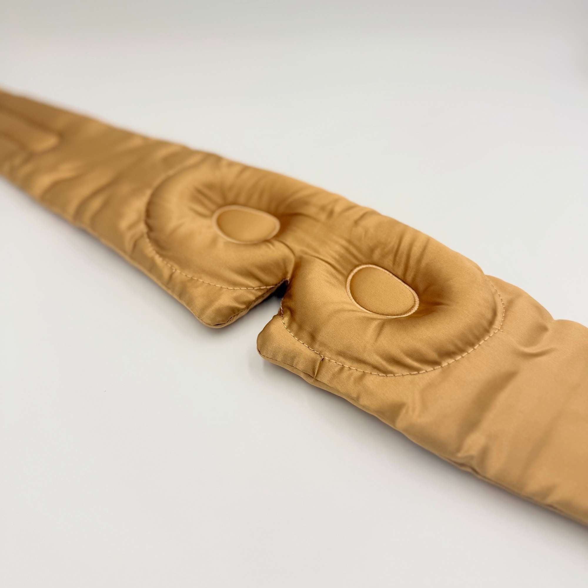 Honeycomb coloured 3d silk eye mask lying flat on a white background