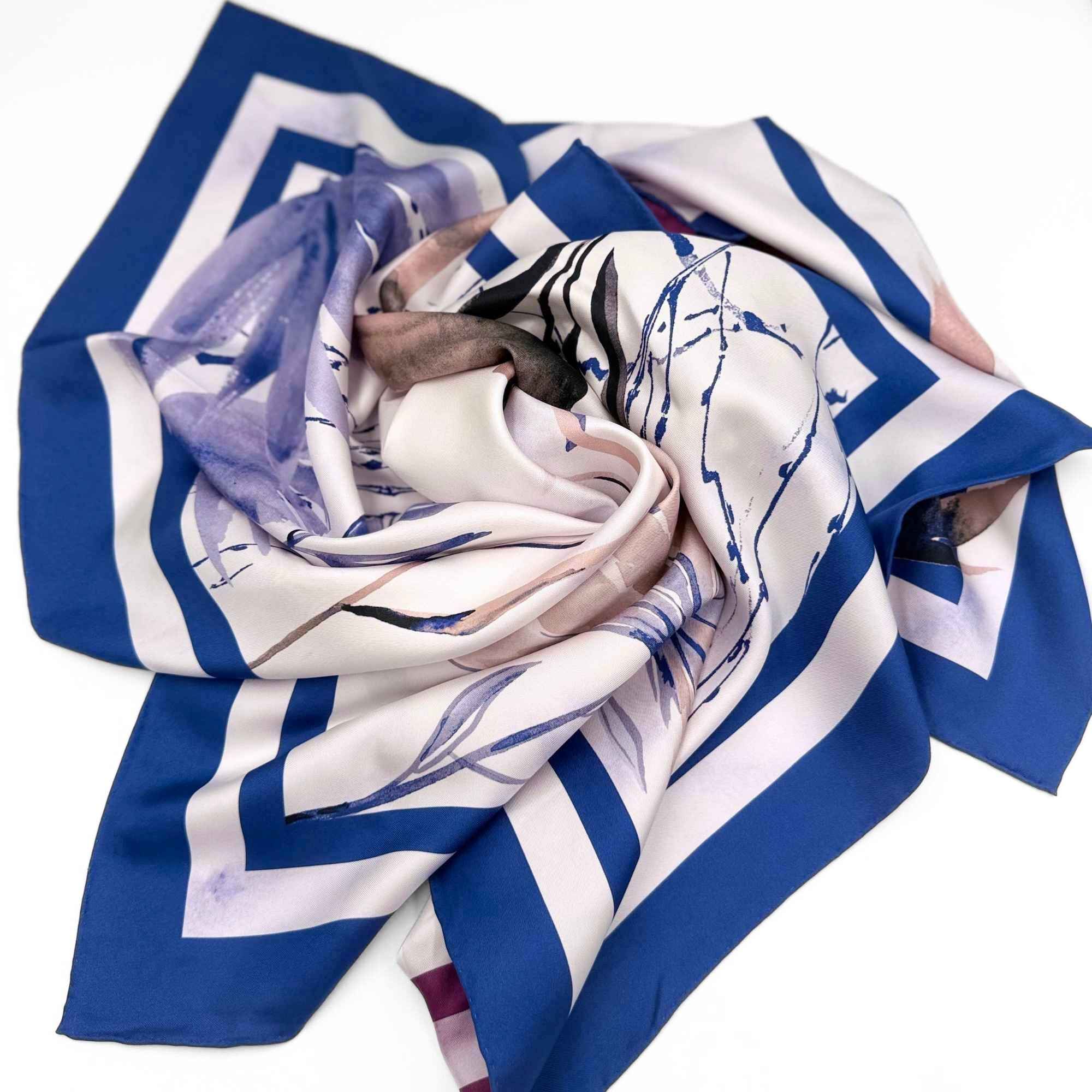Blue, white, and purple patterned silk twill scarf on a white background
