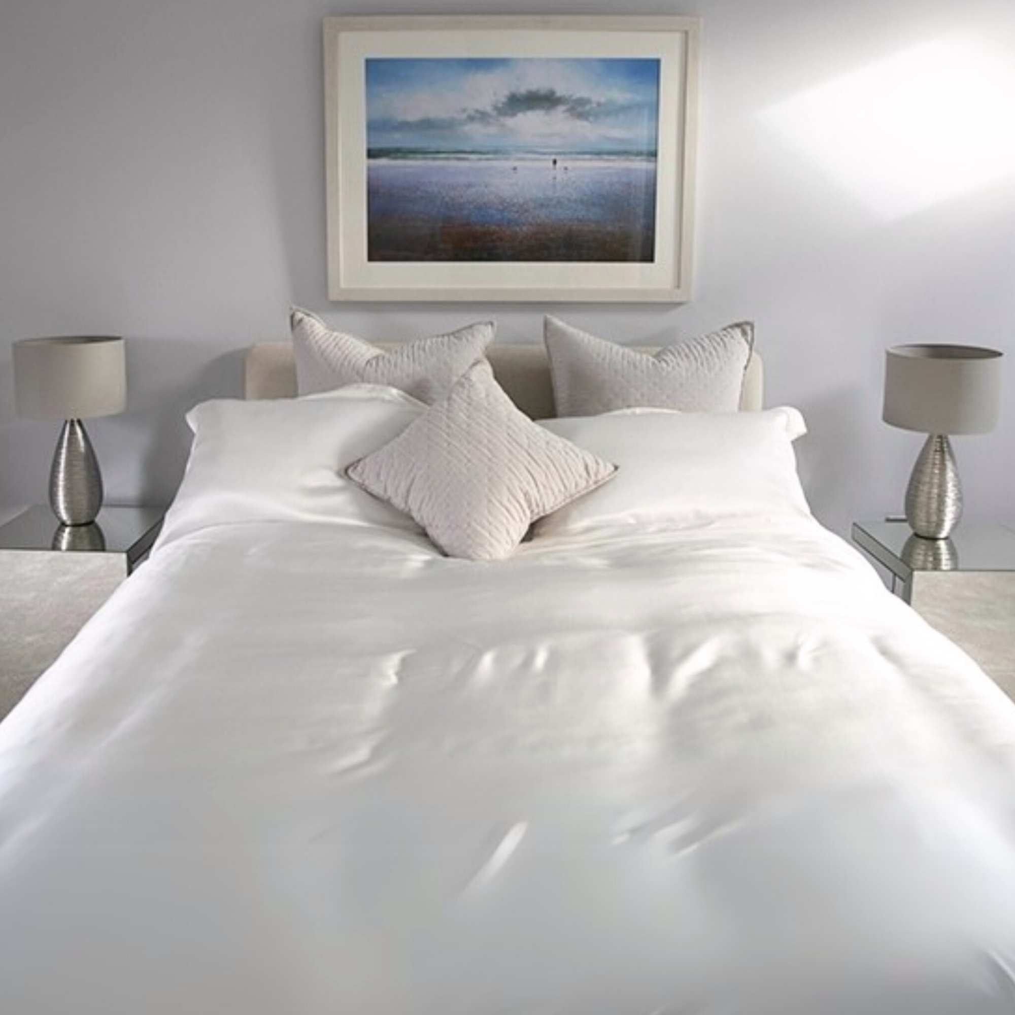 silk bed set with decorative pillows taken from the foot of a bed