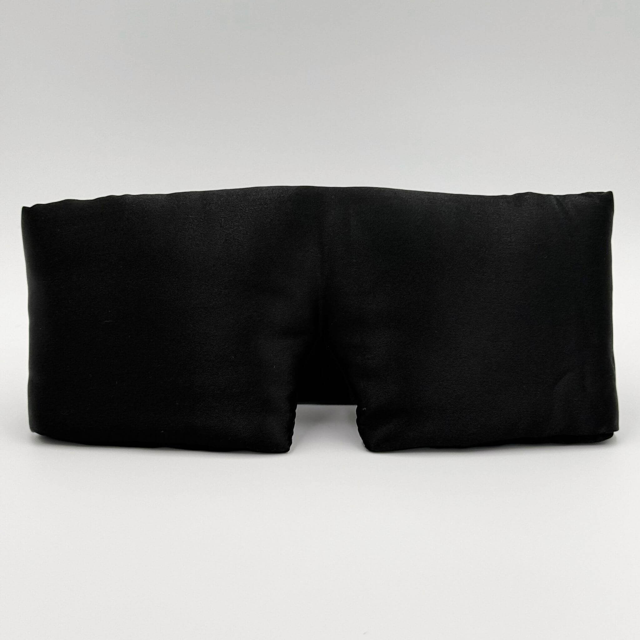 Black silk sleep mask on a white background
