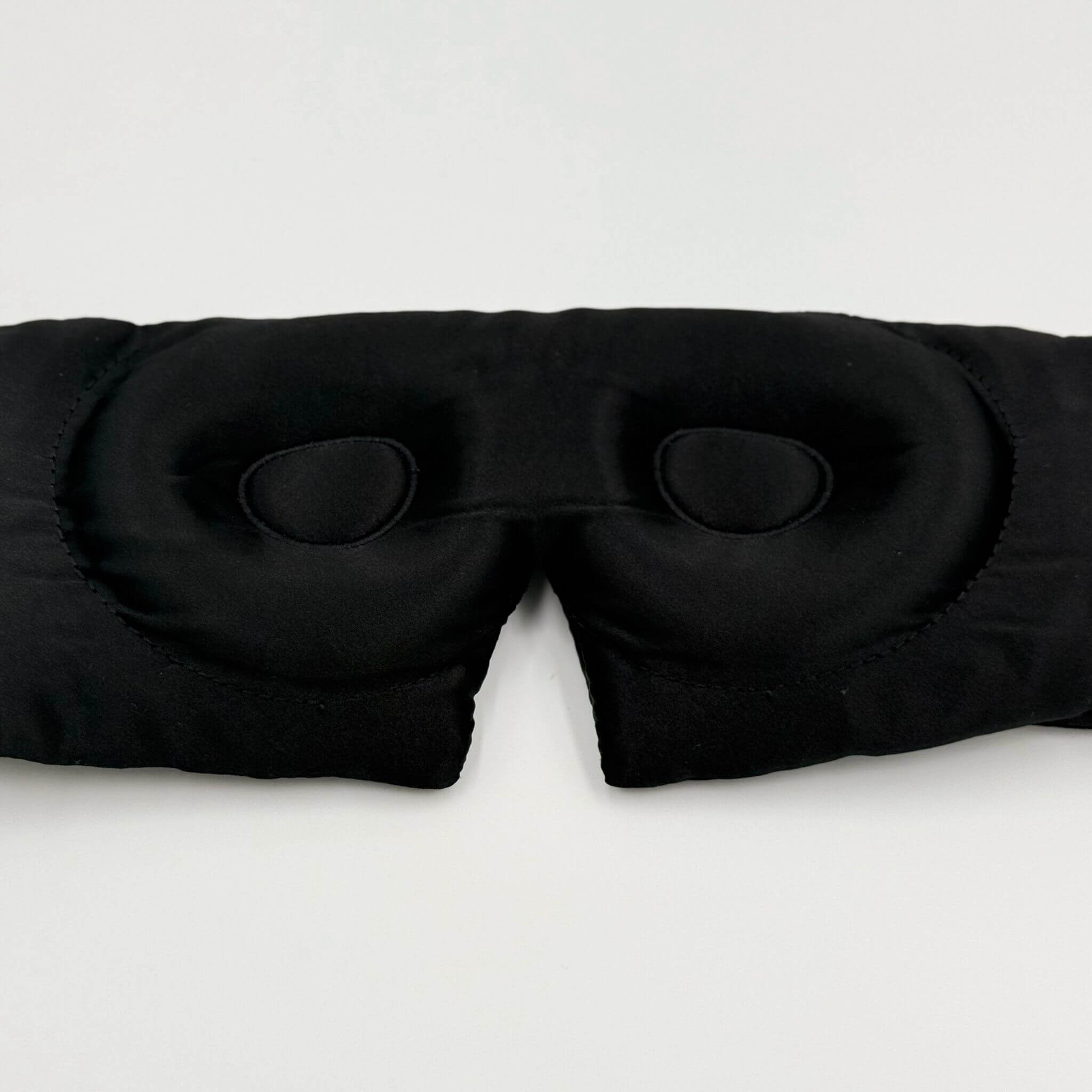 Contoured Black sleep mask on a white background