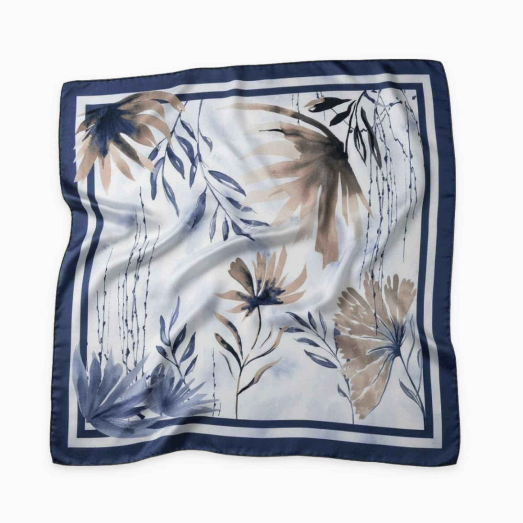 Navy and beige floral patterned silk twill square scarf on a beige background