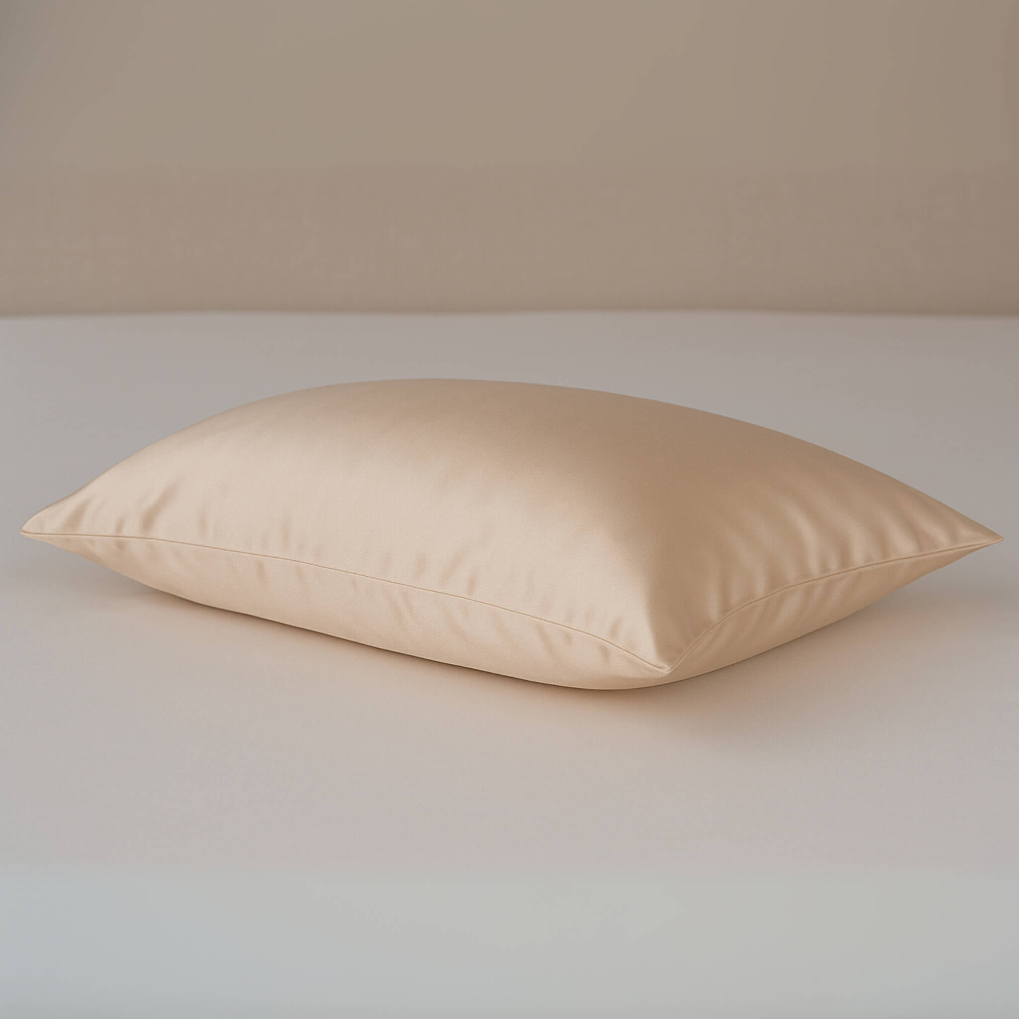 Champagne silk pillowcase on an ivory silk bed sheet