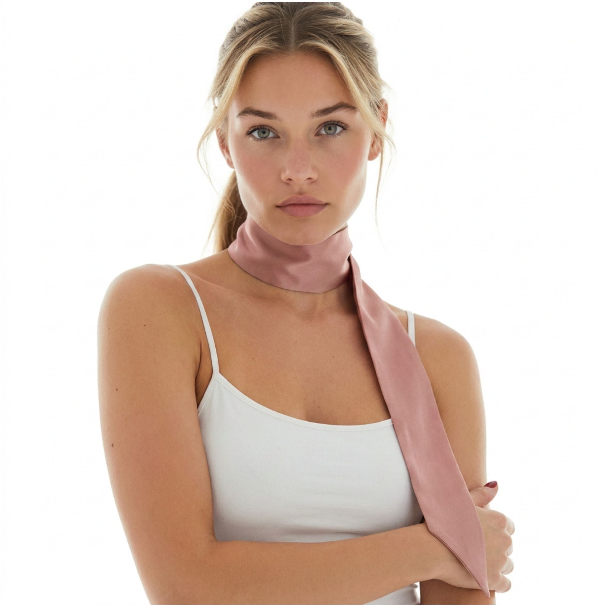 Woman wearing a dusty pink silk skinny scarf around her neck on a white background