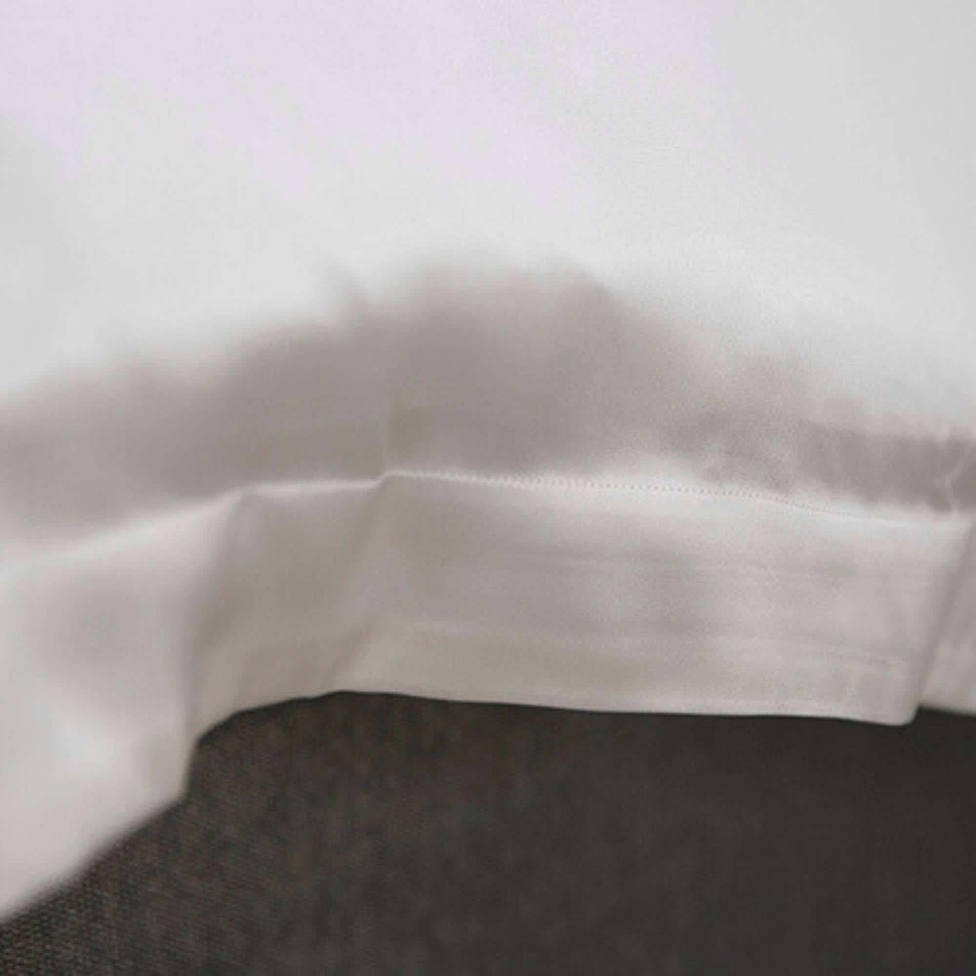 Close-up of an ivory silk edge on a duvet cover