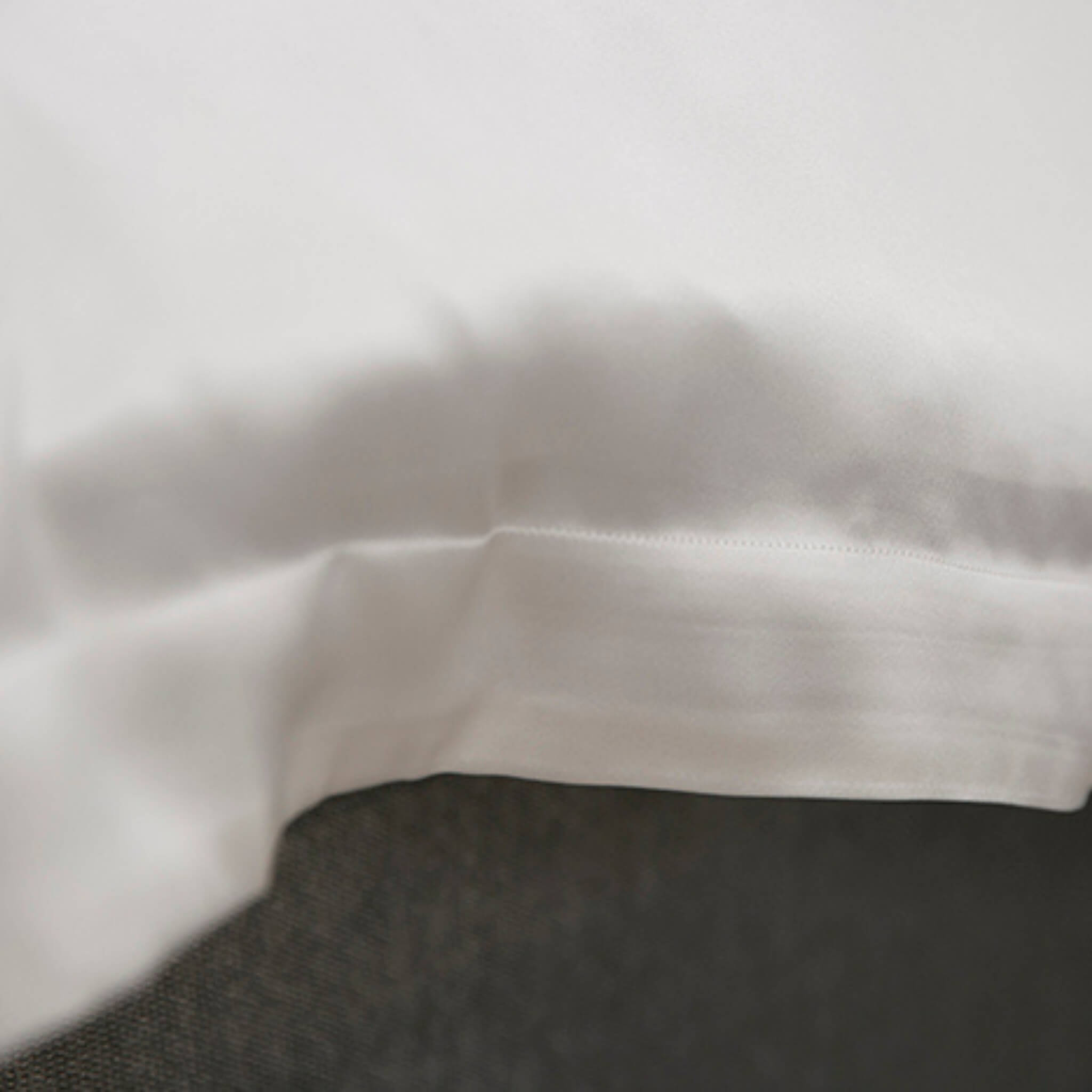 Close-up of an ivory silk edge on a duvet cover