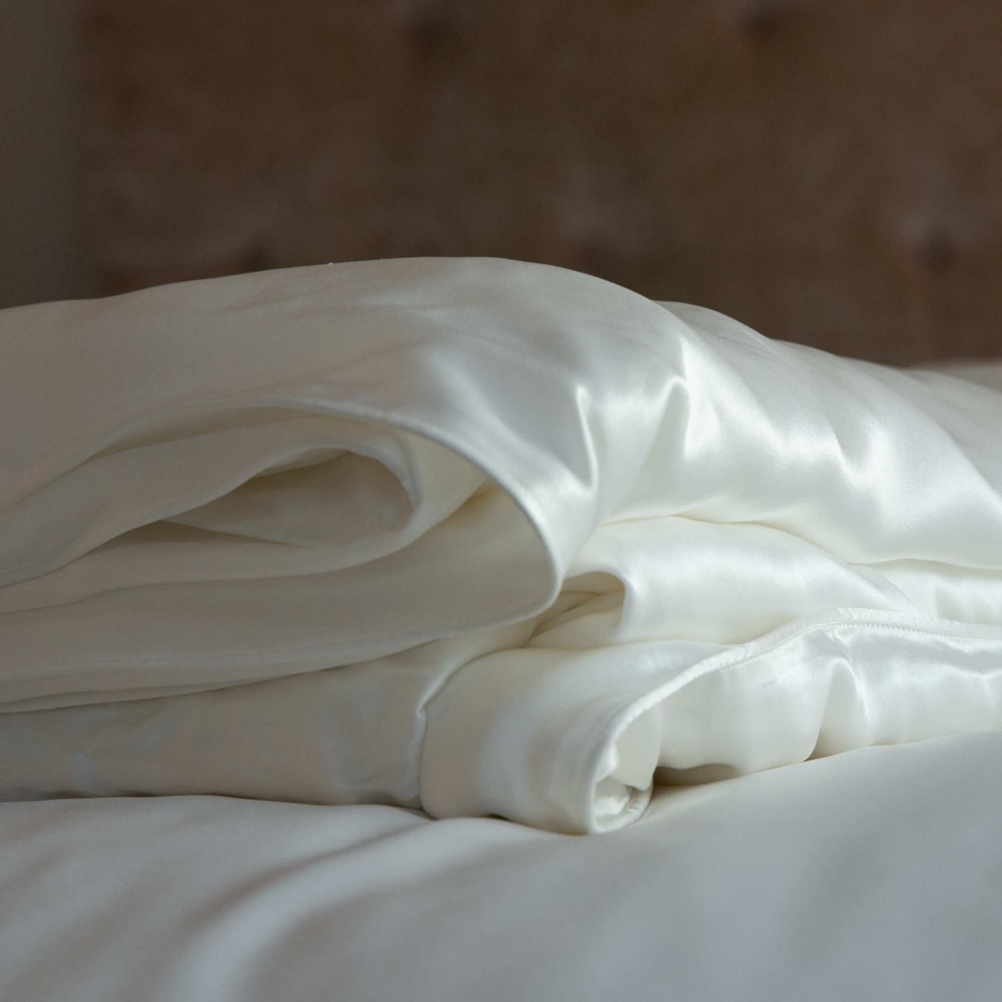 corner of an ivory folded 25 momme silk duvet cover