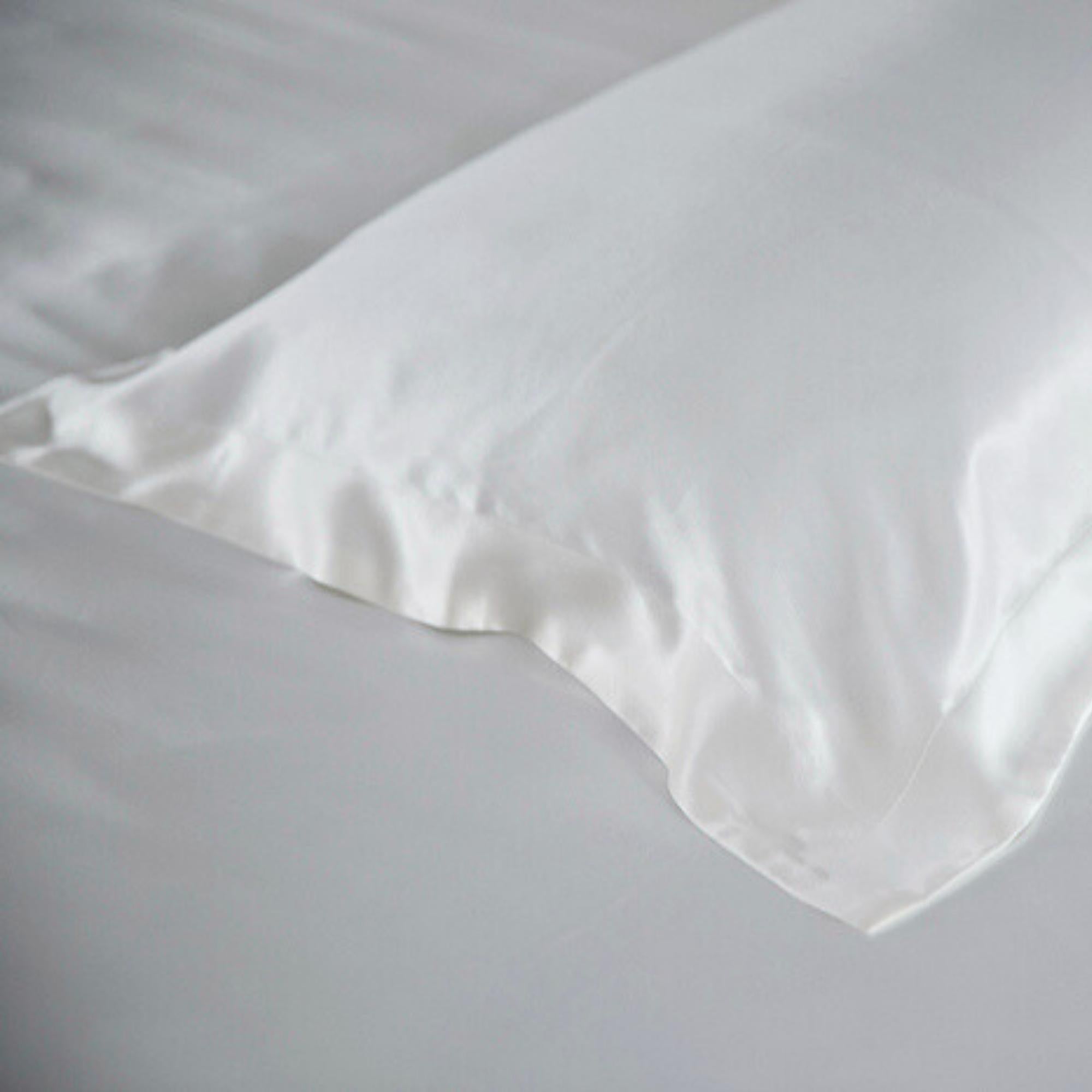 the end of an ivory oxford silk pillowcase