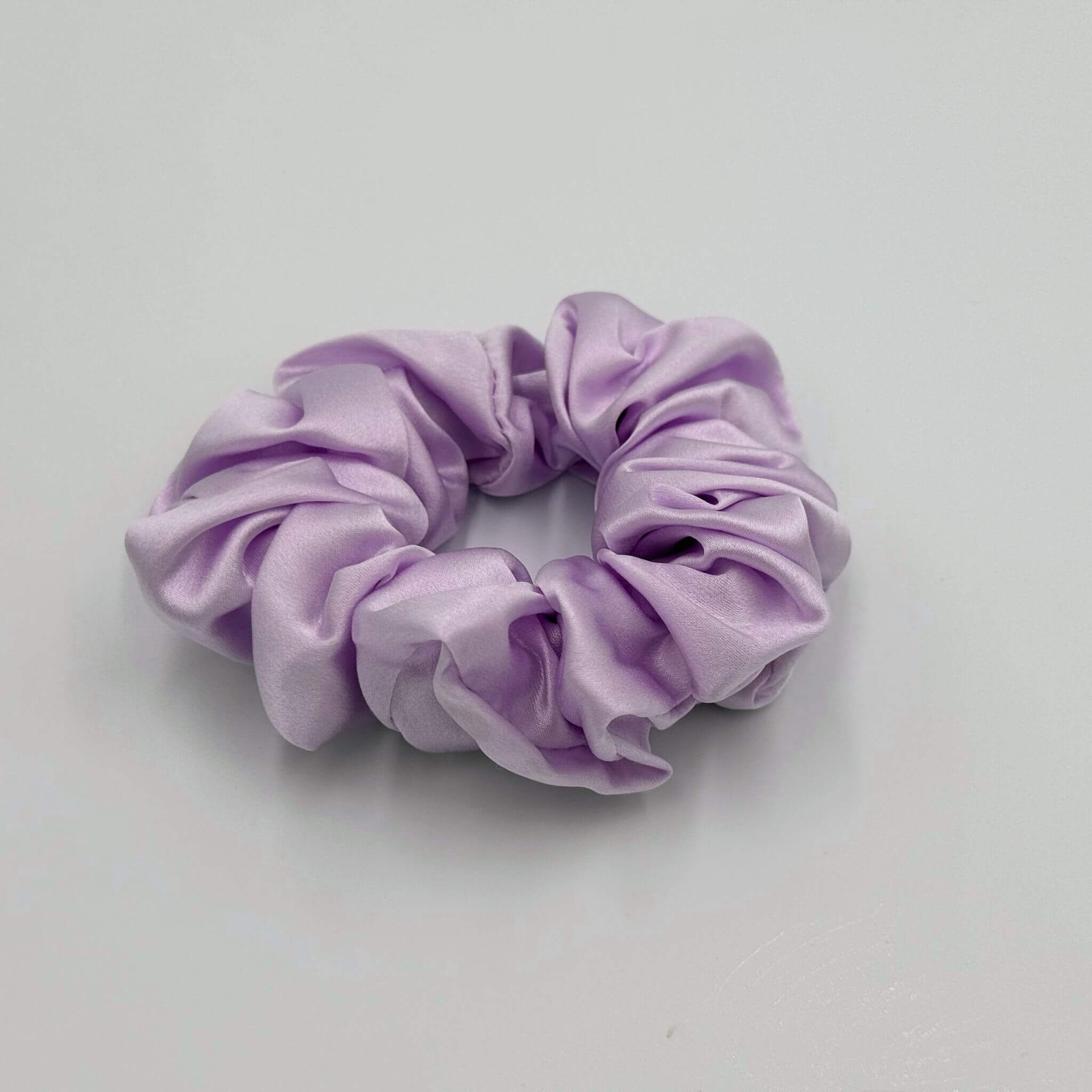 Lavender silk scrunchie on a light gray background