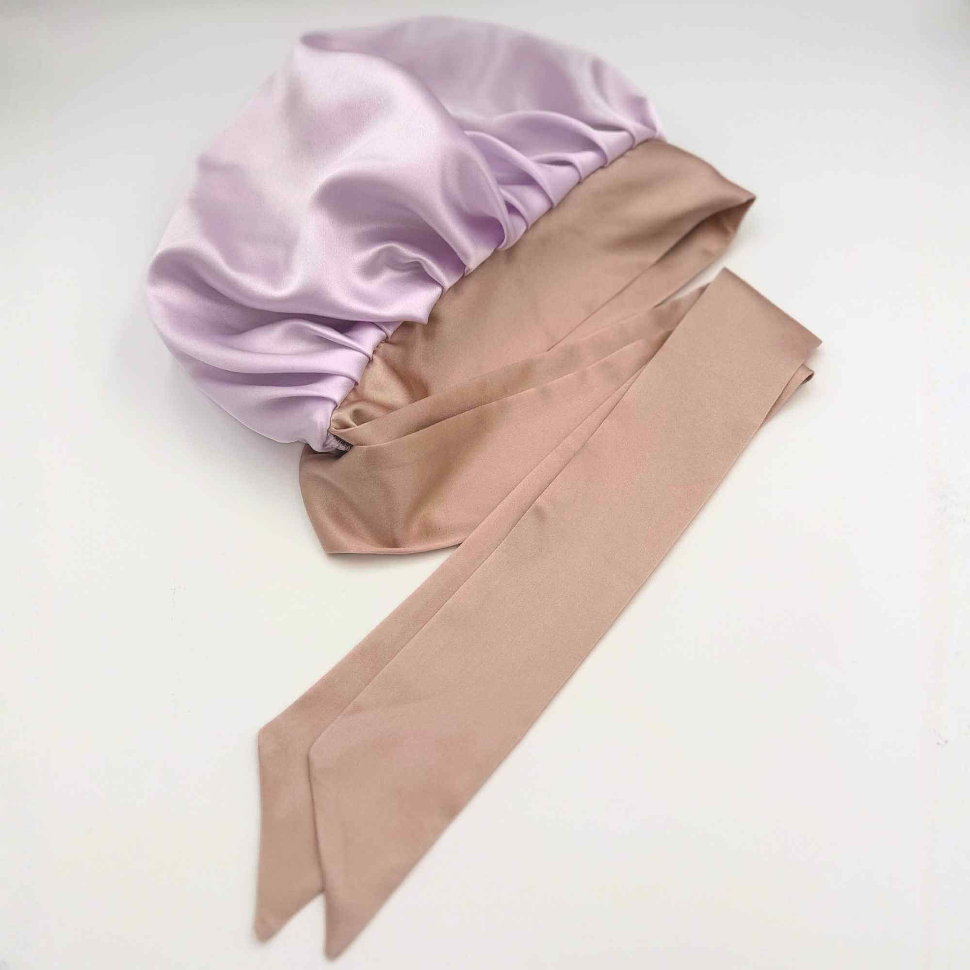 lavender tie silk bonnet lying flat n a white background