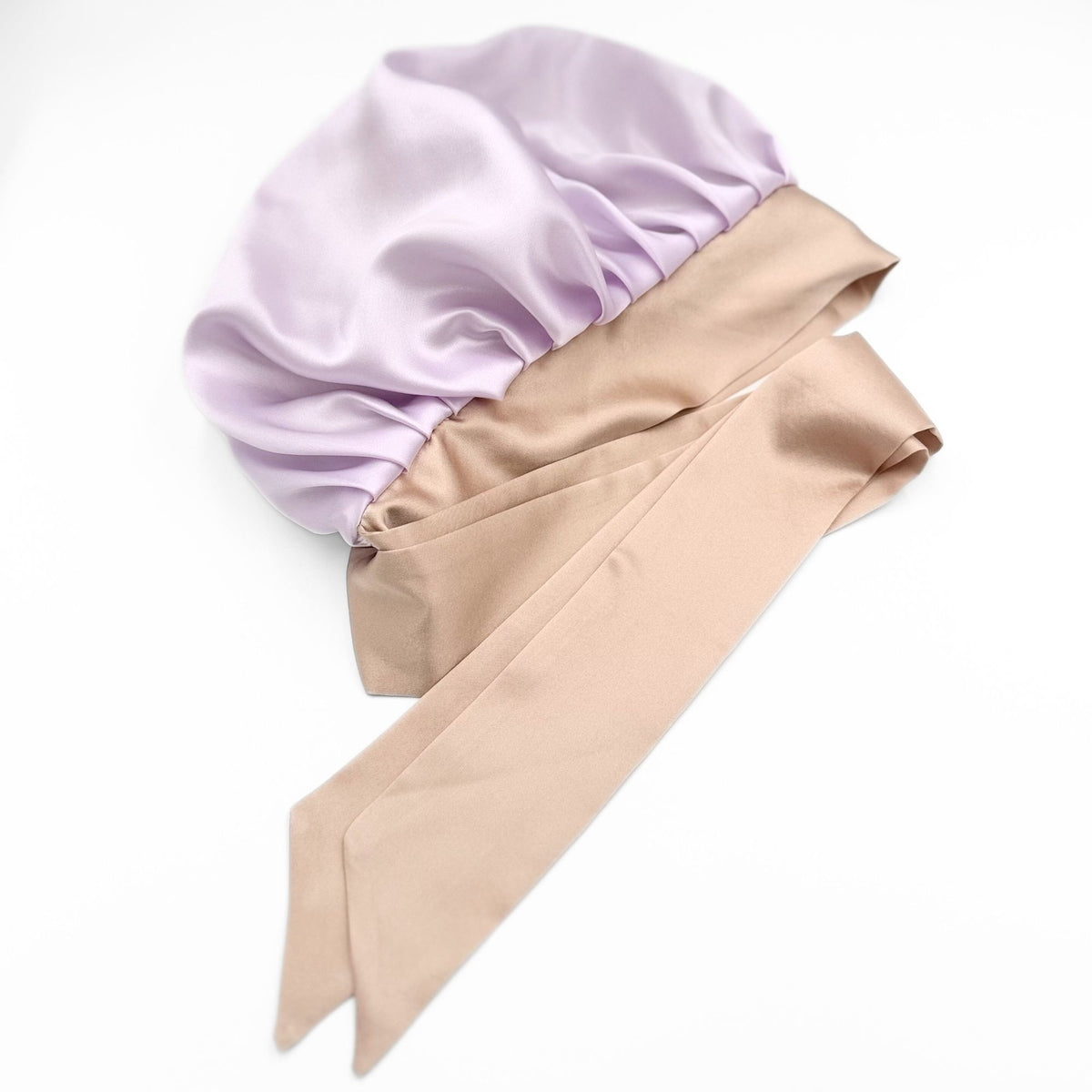 lavender tie silk bonnet lying flat n a white background