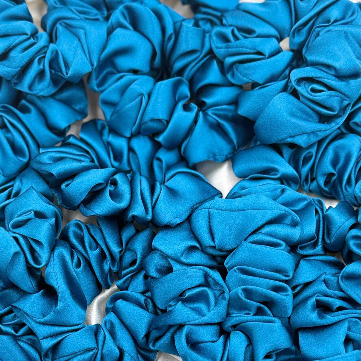 crystal teal mulberry silk scrunchies stacked together