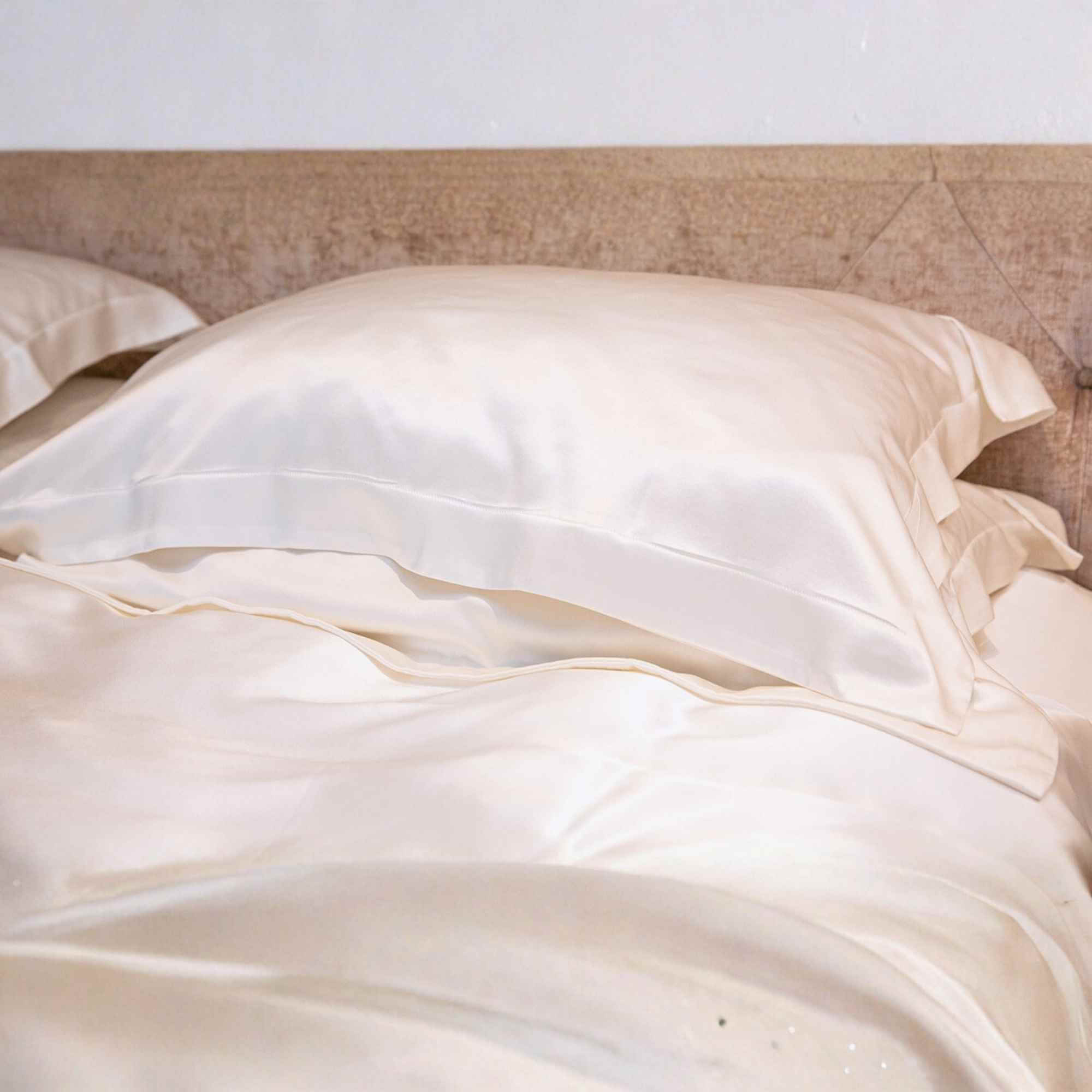 silk oxford pillowcase on a silk bed set in a warm light