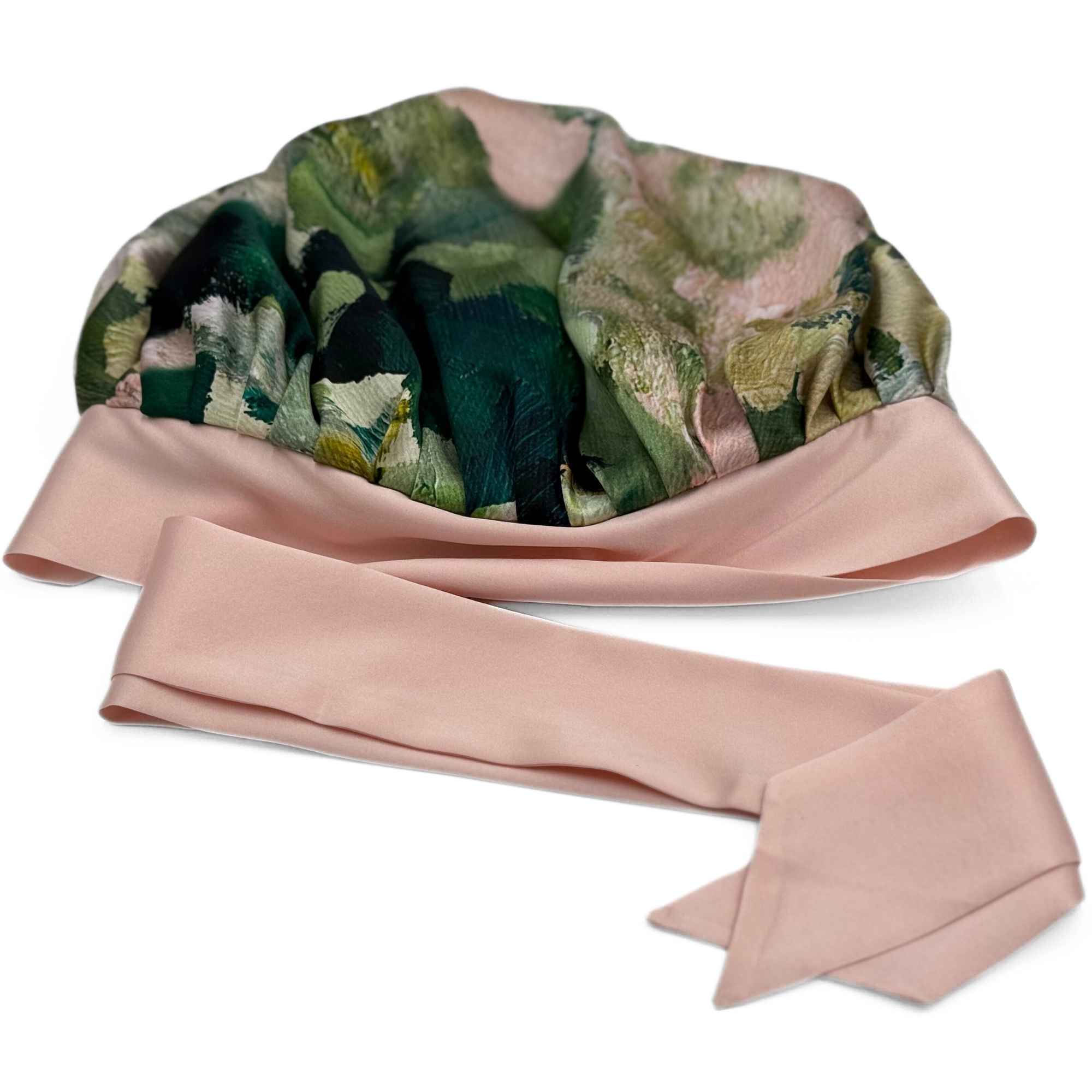 Floral-patterned silk bonnet with a pink tie on a white background