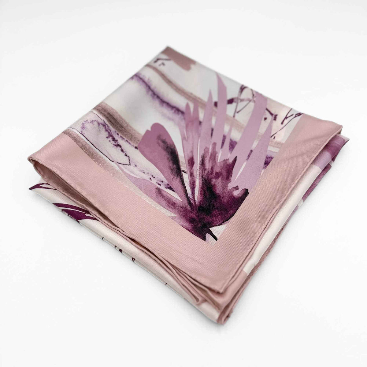 Folded silk twill scarf with floral pattern on a white background