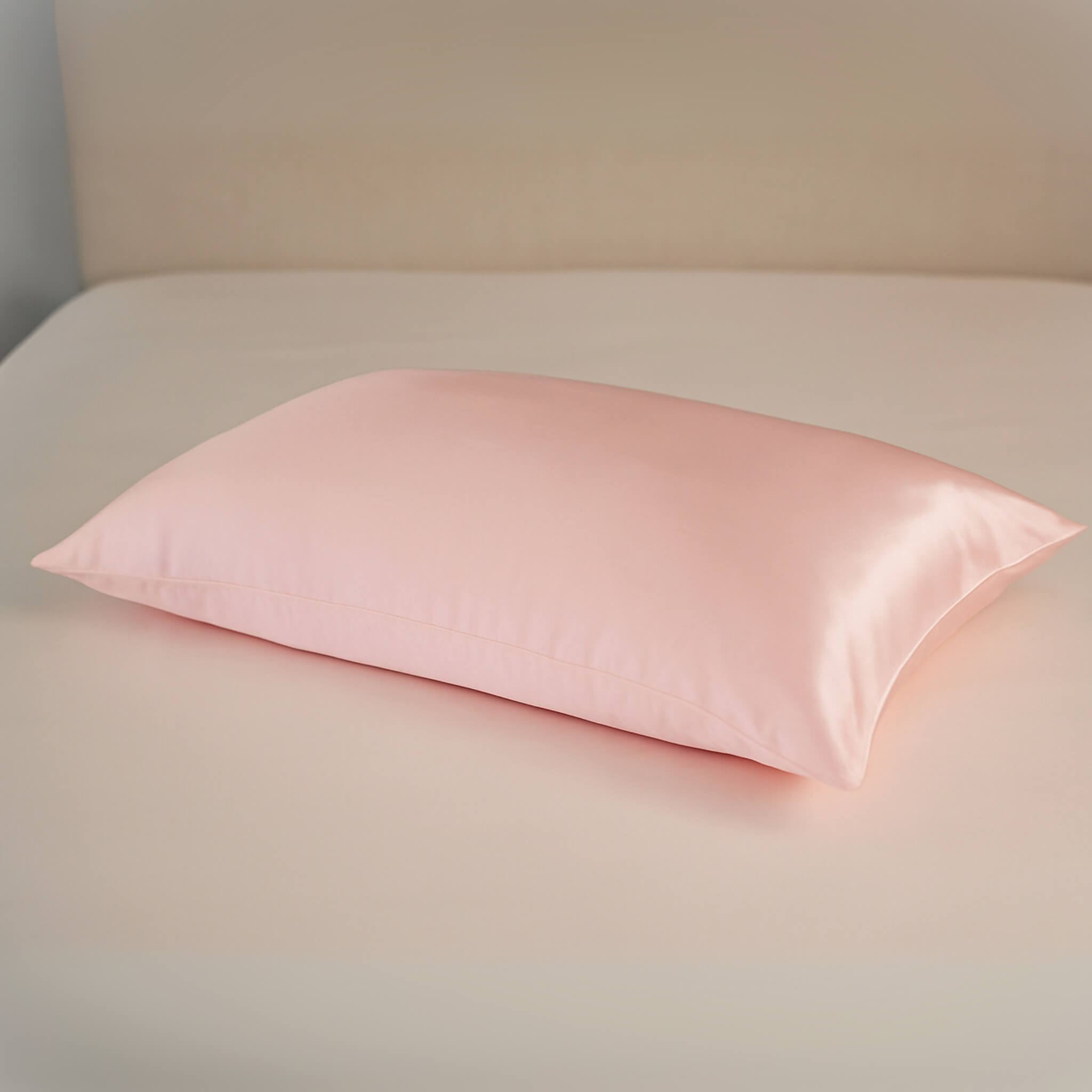 Pink silk pillowcase on an ivory silk bed sheet