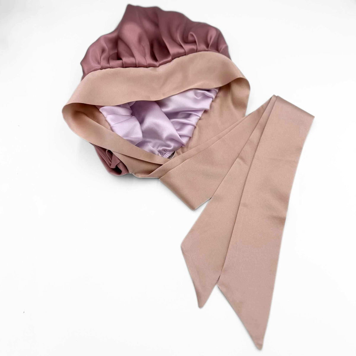 Pink and lavender silk hair bonnet on a white background