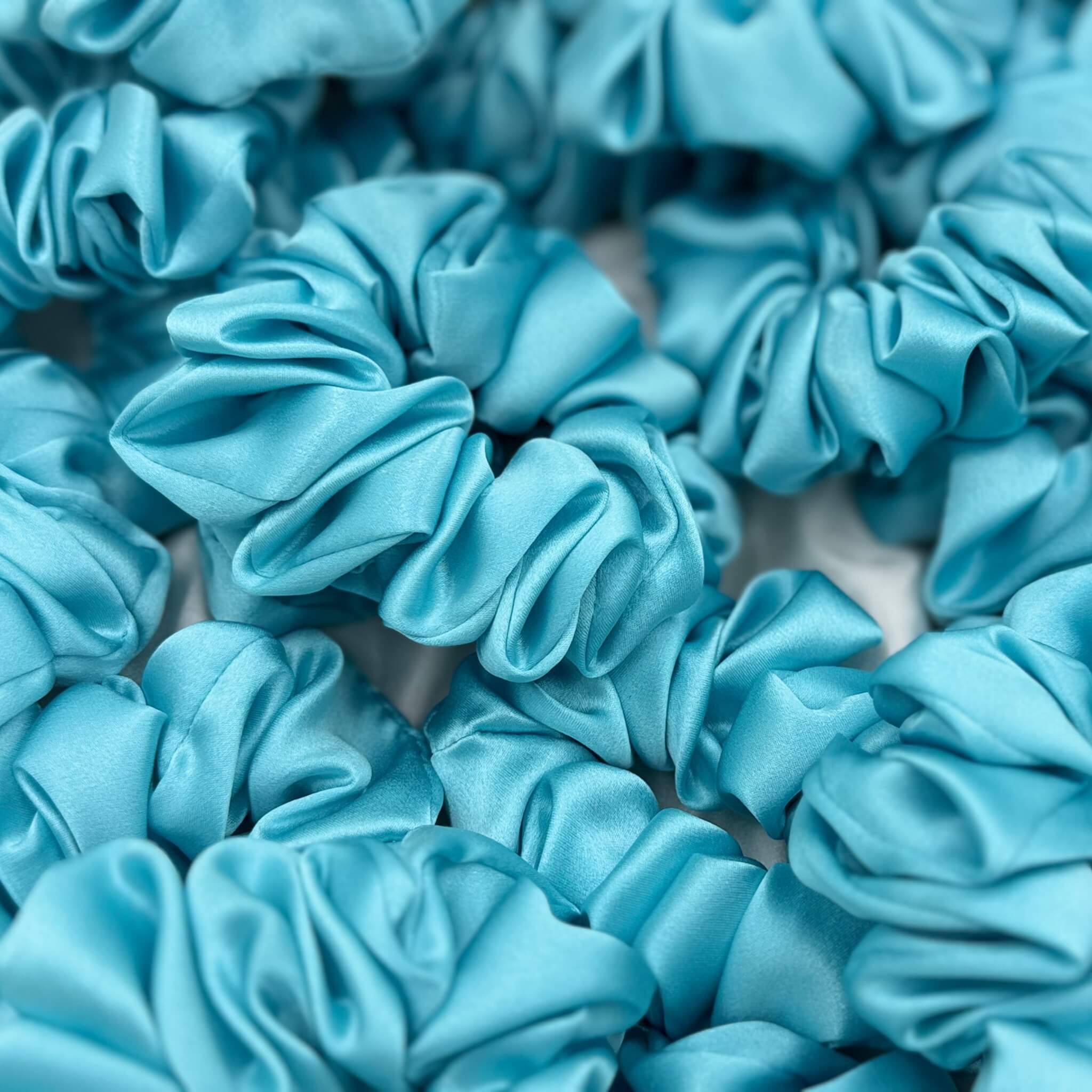 robin's egg blue silk scrunchies in a pile