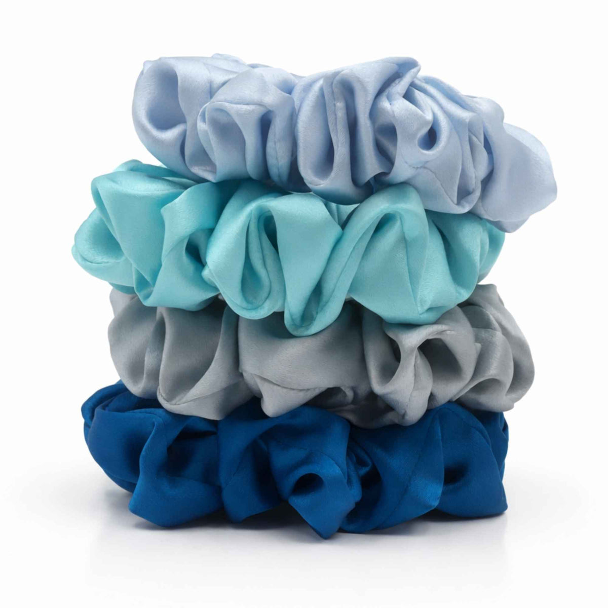 Stack of blue silk scrunchies on a white background