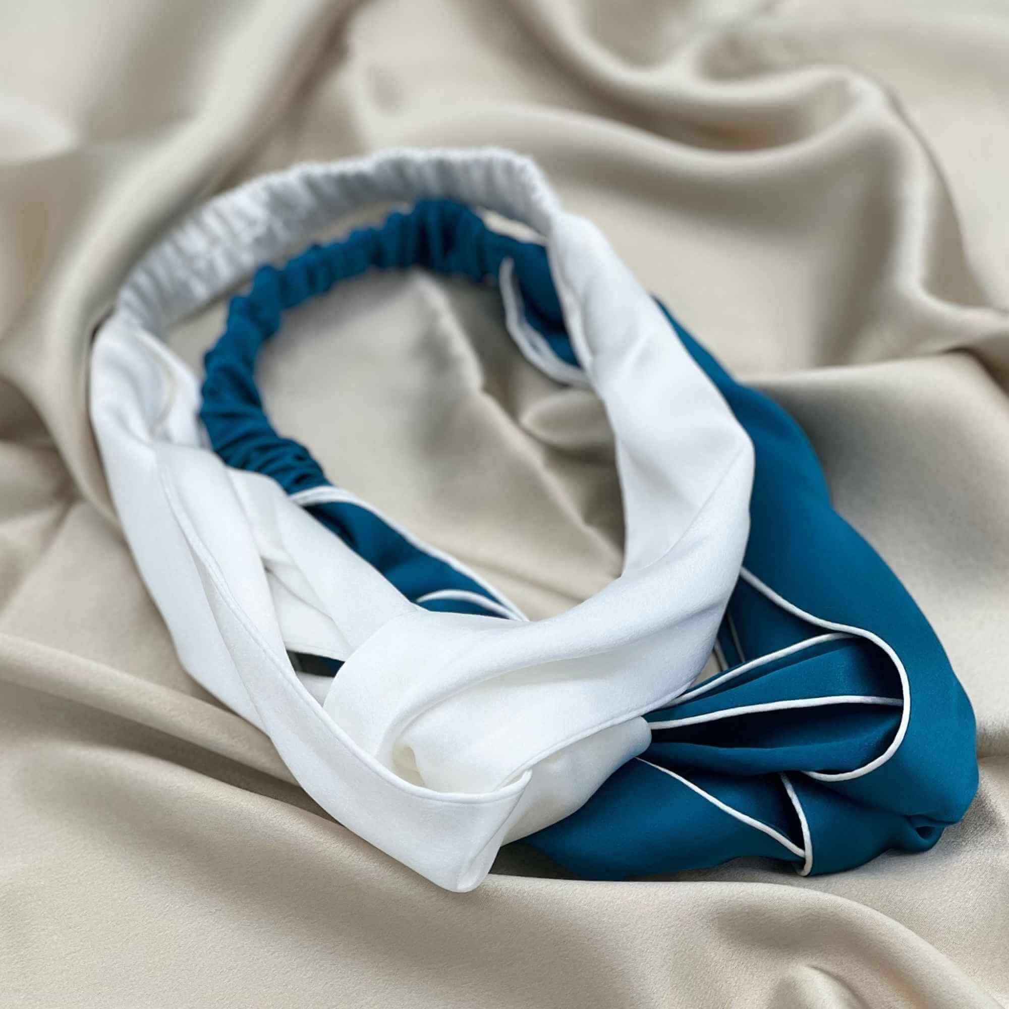 teal blue and ivory white mulberry silk headbands on a champagne silk fabric