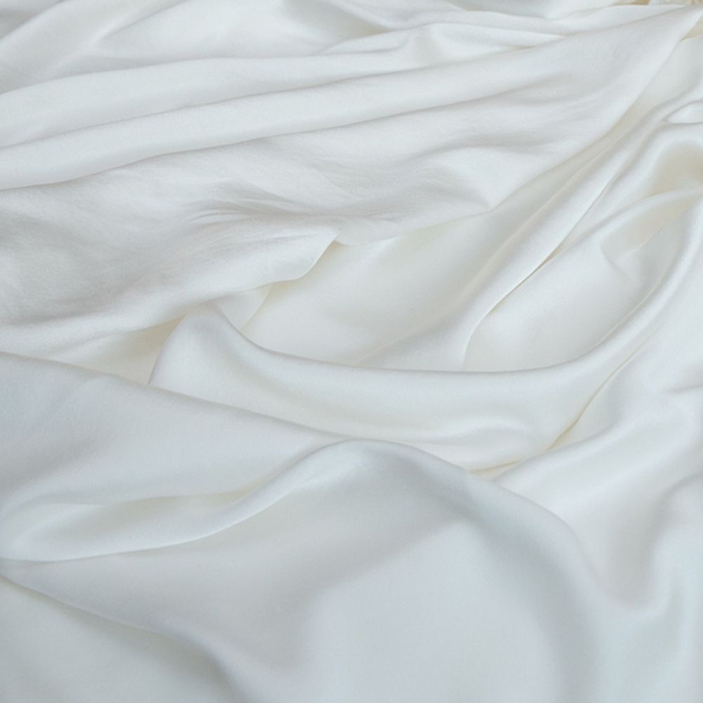 close of f an ivory silk textured fabric