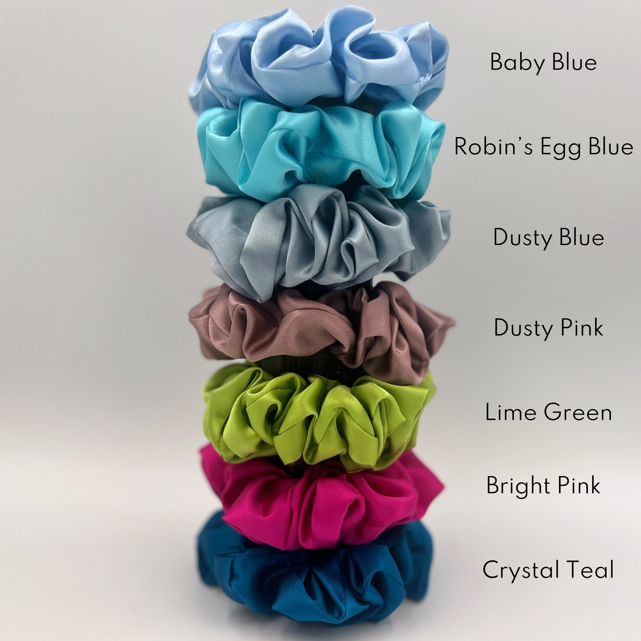 ‘Dusky Pink’, 'Bright Pink', 'Lime Green' ,'Baby Blue', 'Crystal Teal', 'Robin's Egg Blue' and 'Dusty Blue' stacked with their names next to them in black text