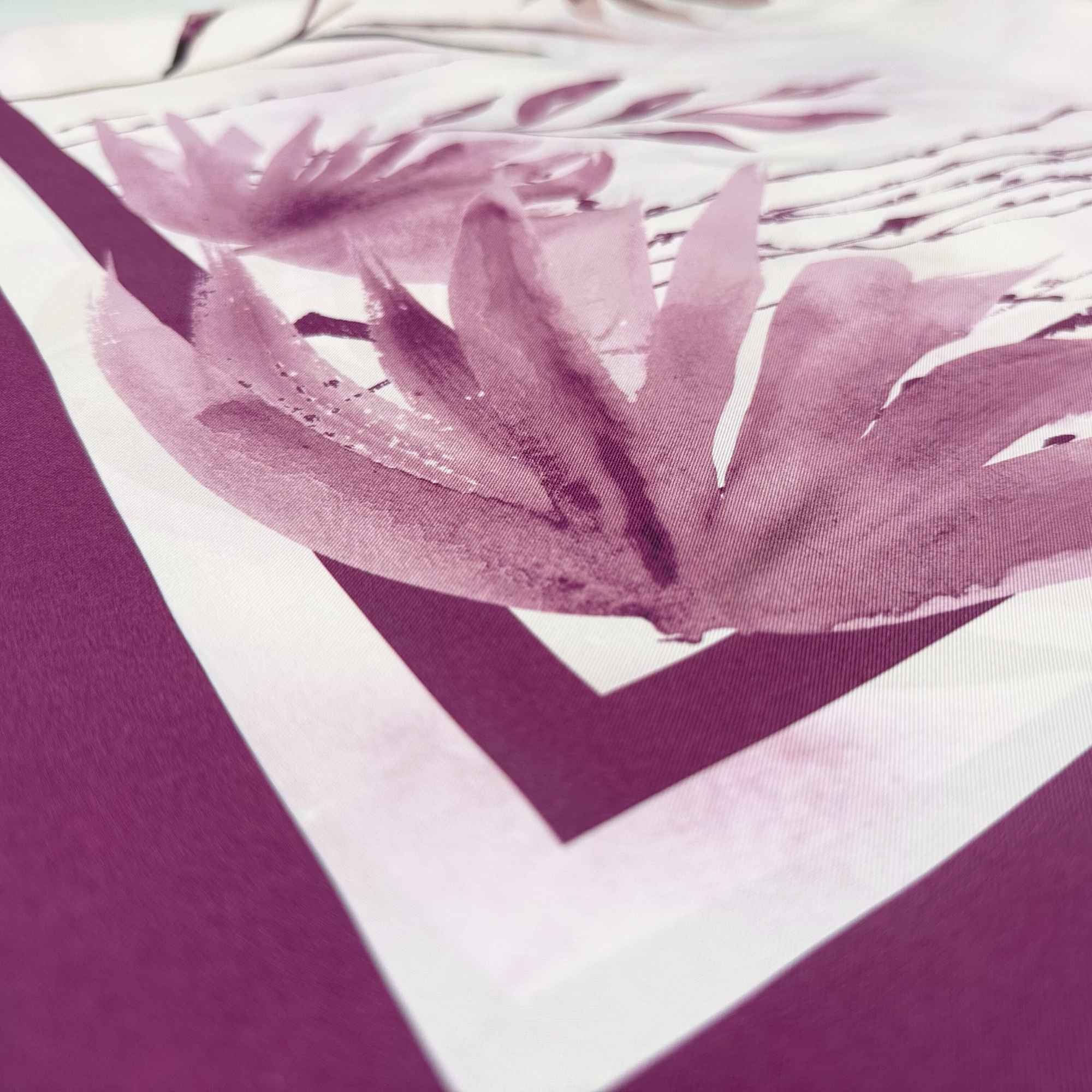 Close-up of a purple silk twill with a pattern in the background