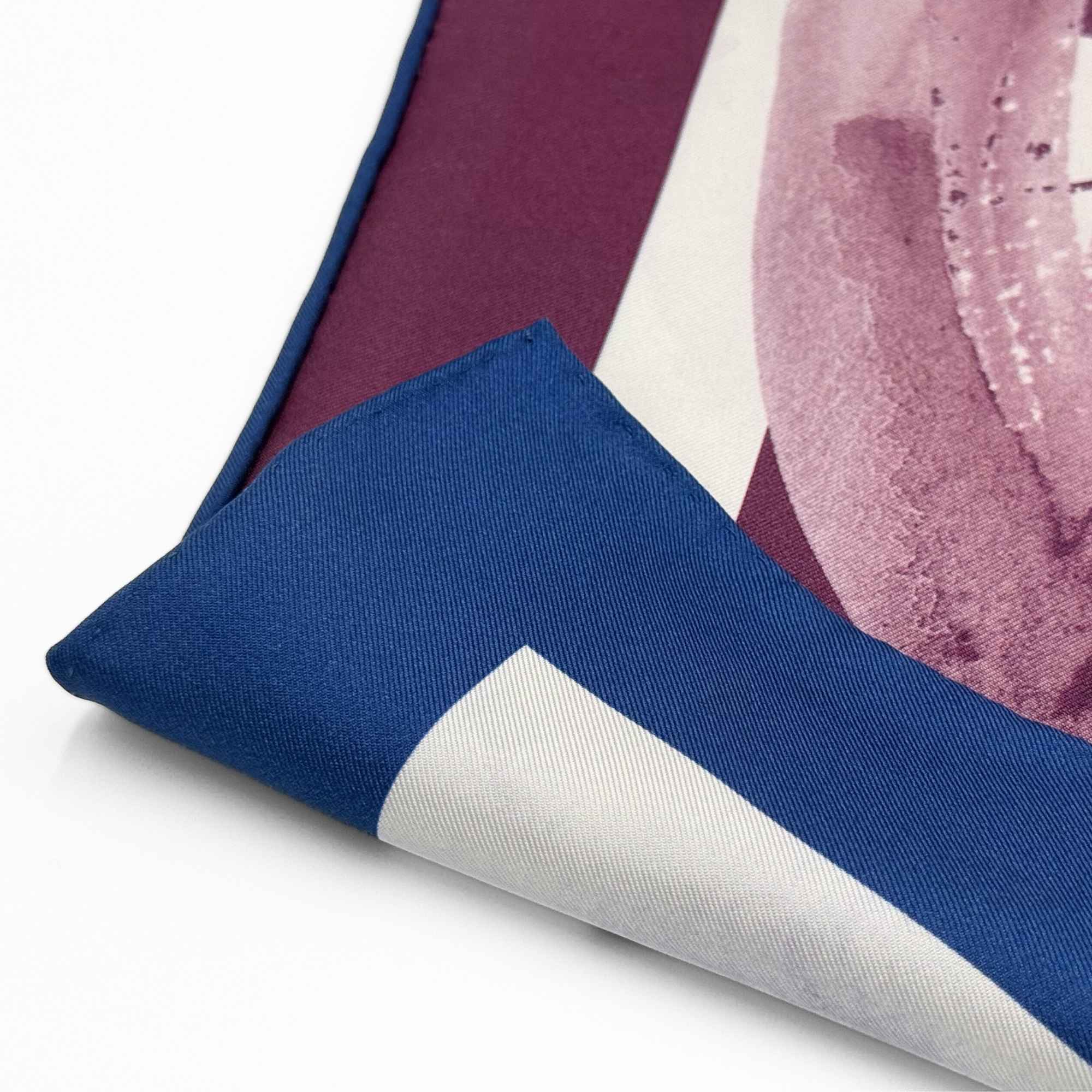 Close-up of a blue silk twill with a patterned background