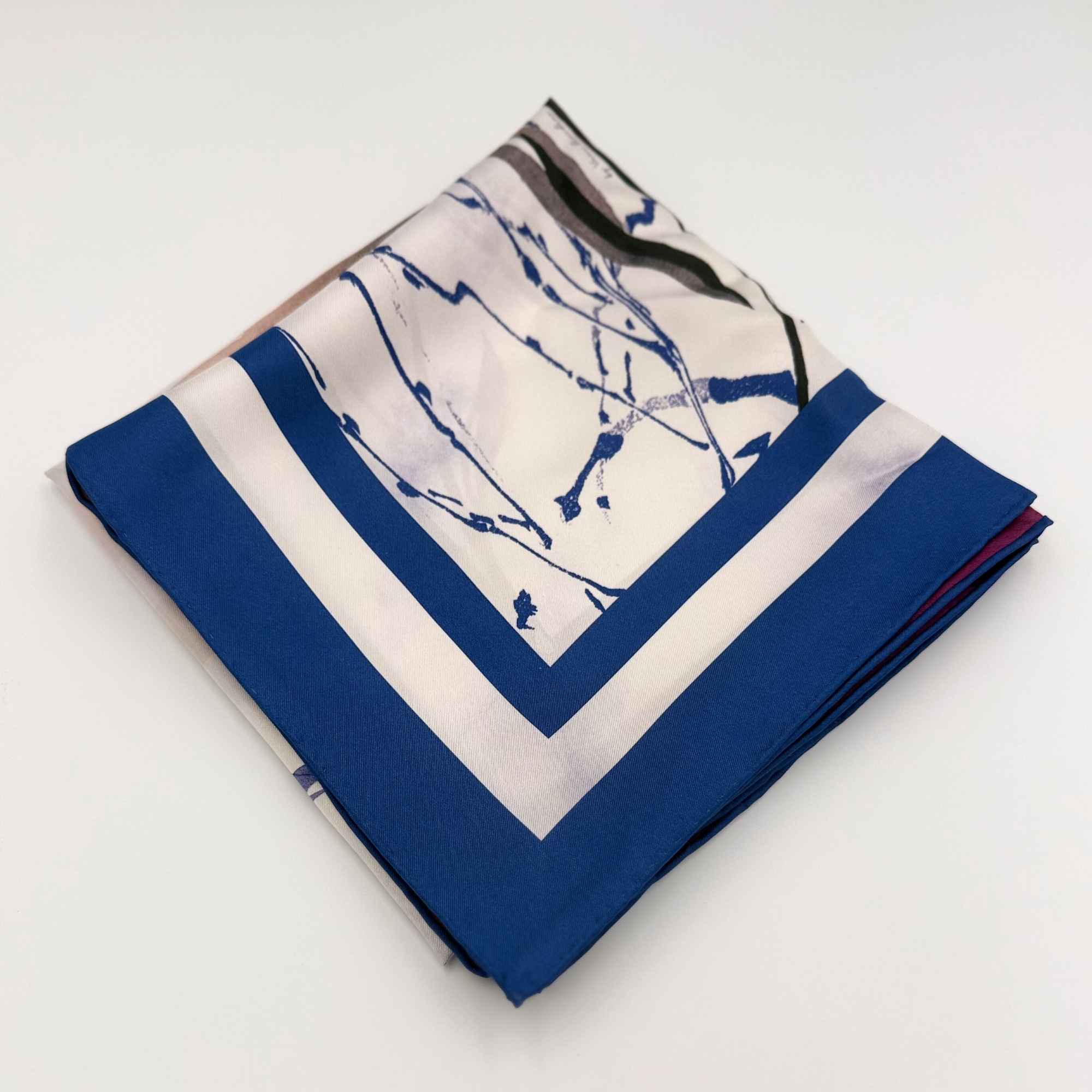 Folded 'Beautiful Botanicals' silk twill scarf on a white background