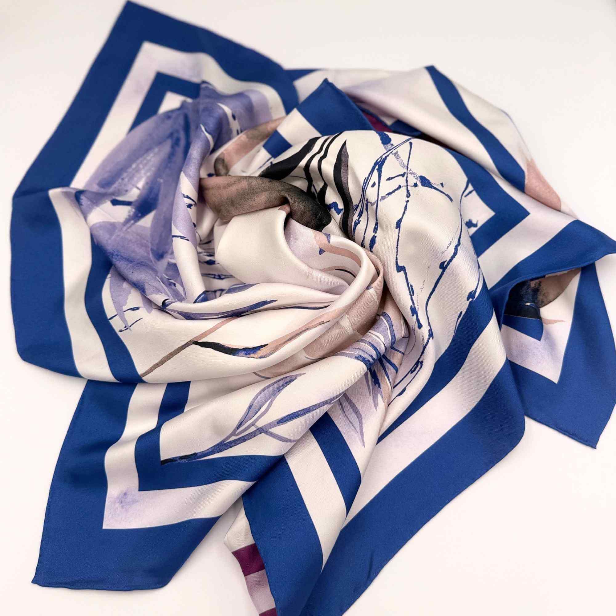 Blue, white, and purple patterned silk twill scarf on a white background