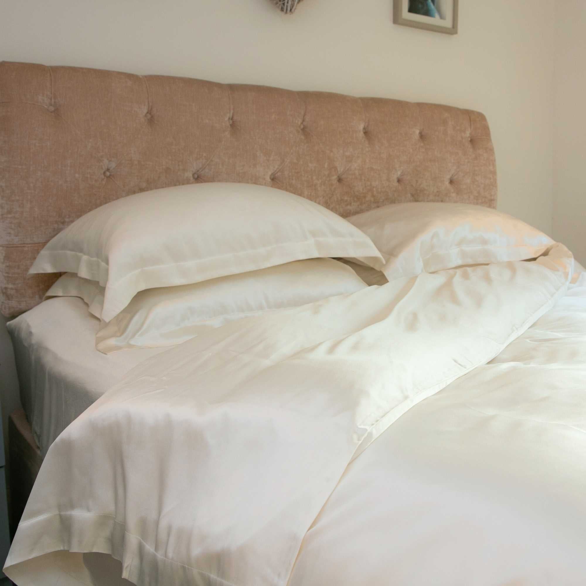 Silk bed set with the duvet folded slightly back at the corner