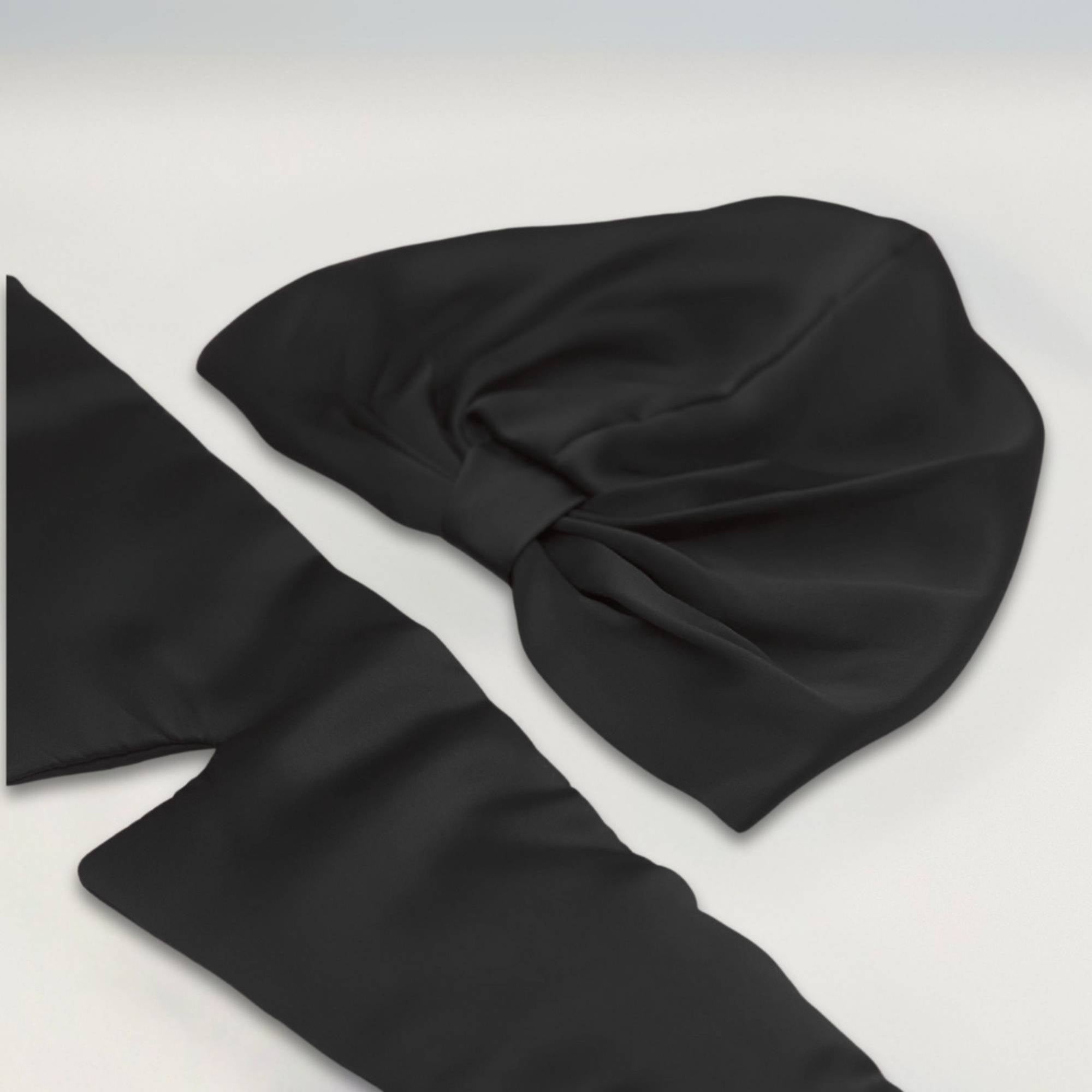 a black silk bonnet and eye mask set, with the eye mask opened out to show its length