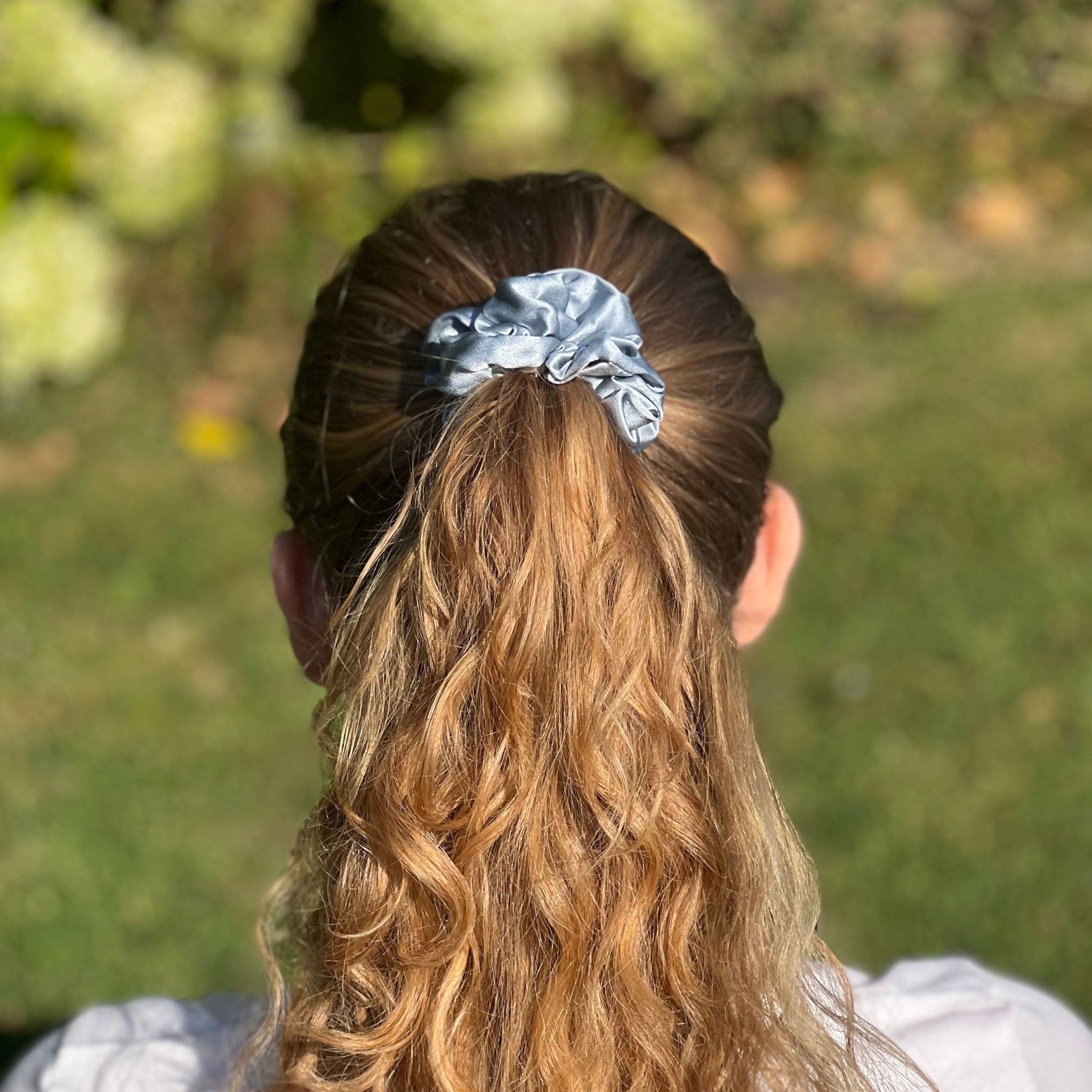 dusty blue silk scrunchie in a high ponytail