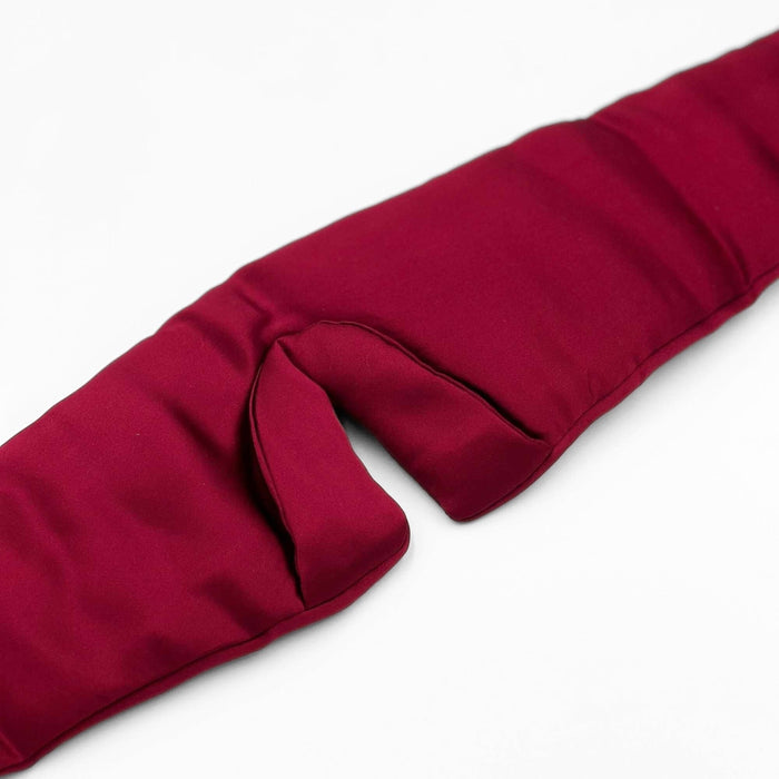 close up of the padded nose area of an adjustable red silk eye mask
