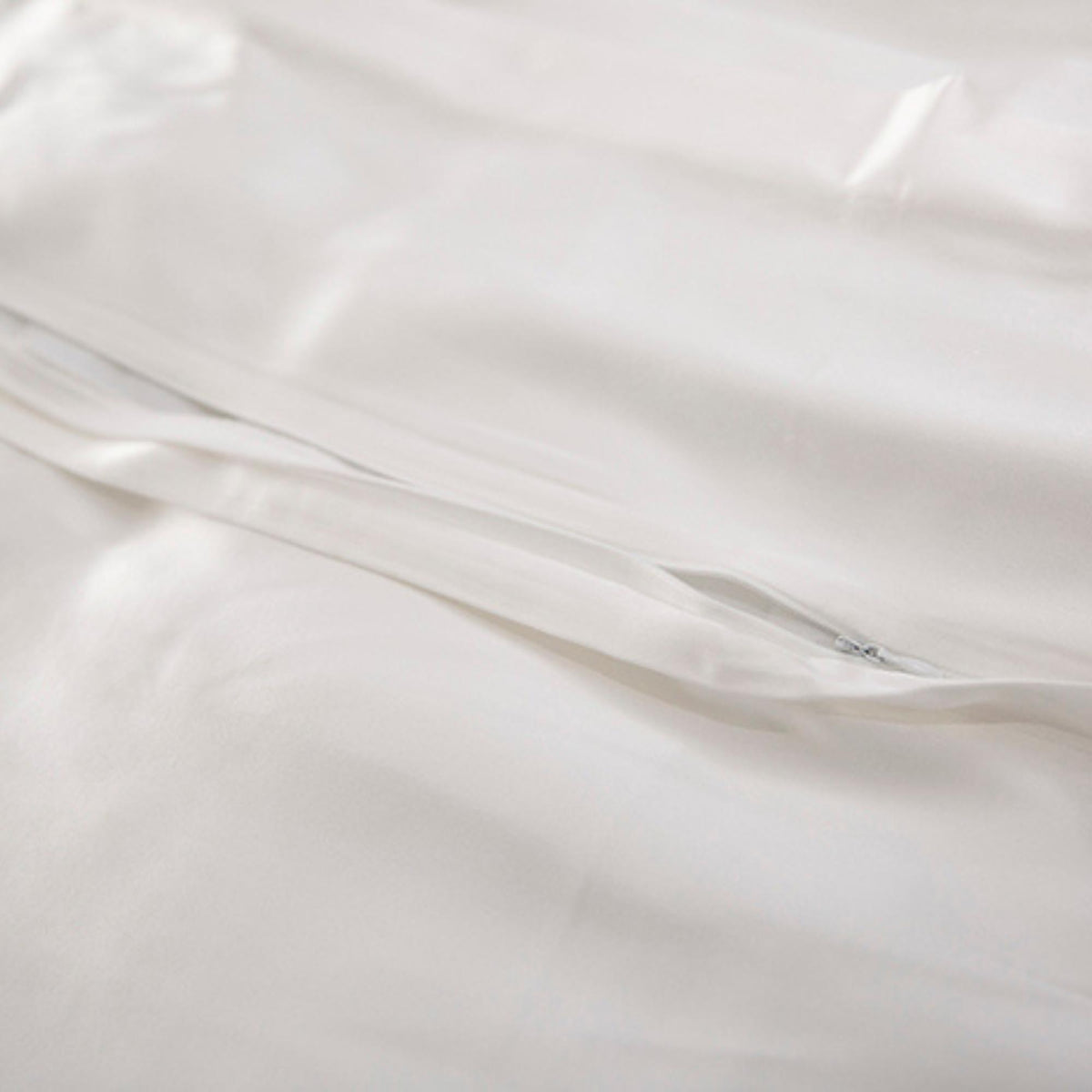 Close-up of ivory silk fabric with concealed zipper