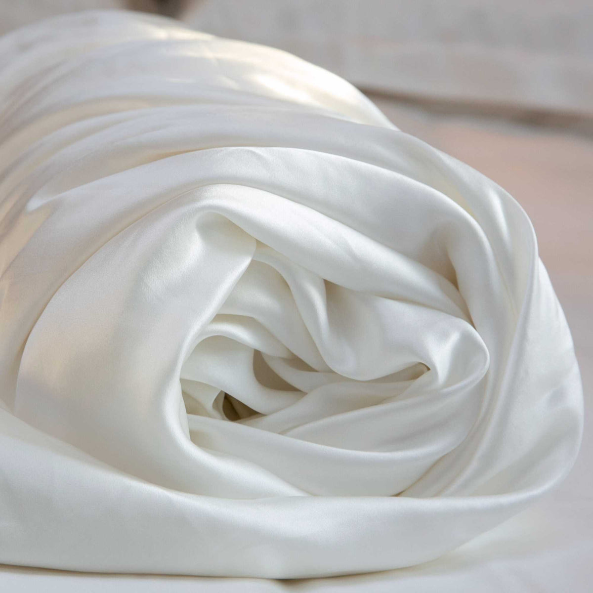 rolled up ivory 25 momme silk duvet cover close up