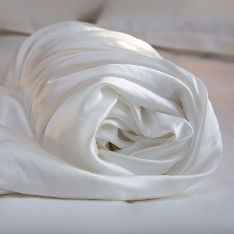 rolled up ivory 25 momme silk duvet cover close up