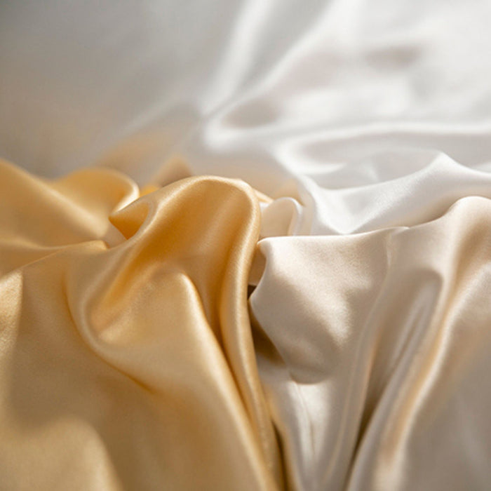 close up of gold, champagne and ivory silk pillowcases