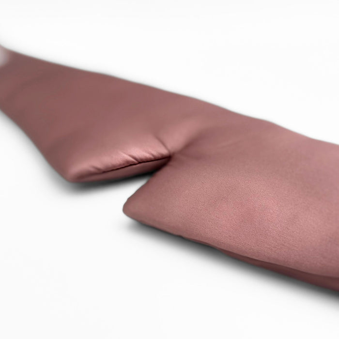 close up of the front of the padded and adjustable dusty pink mulberry silk eye mask