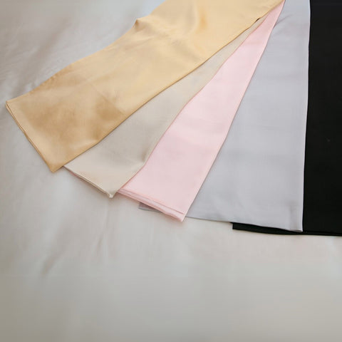 gold, champagne, pink, silver and black 25 momme silk pillowcases folded and fanned out