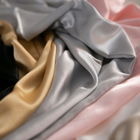 black, gold, silver, pink and champagne 25 momme silk pillowcases scrunched together