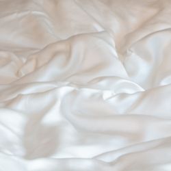 Close-up of smooth, ivory silk textured fabric