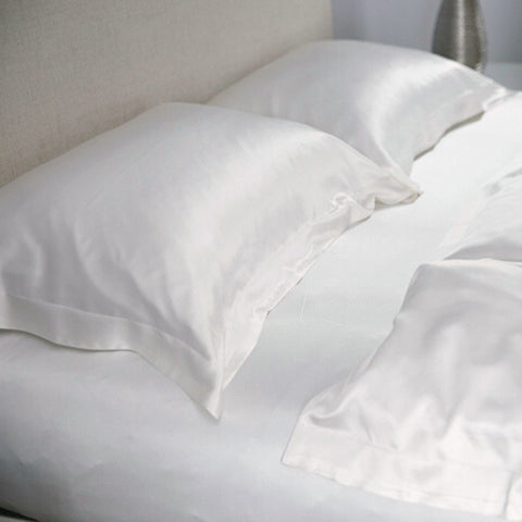 ivory oxford 25 momme silk pillowcase on a silk sheet