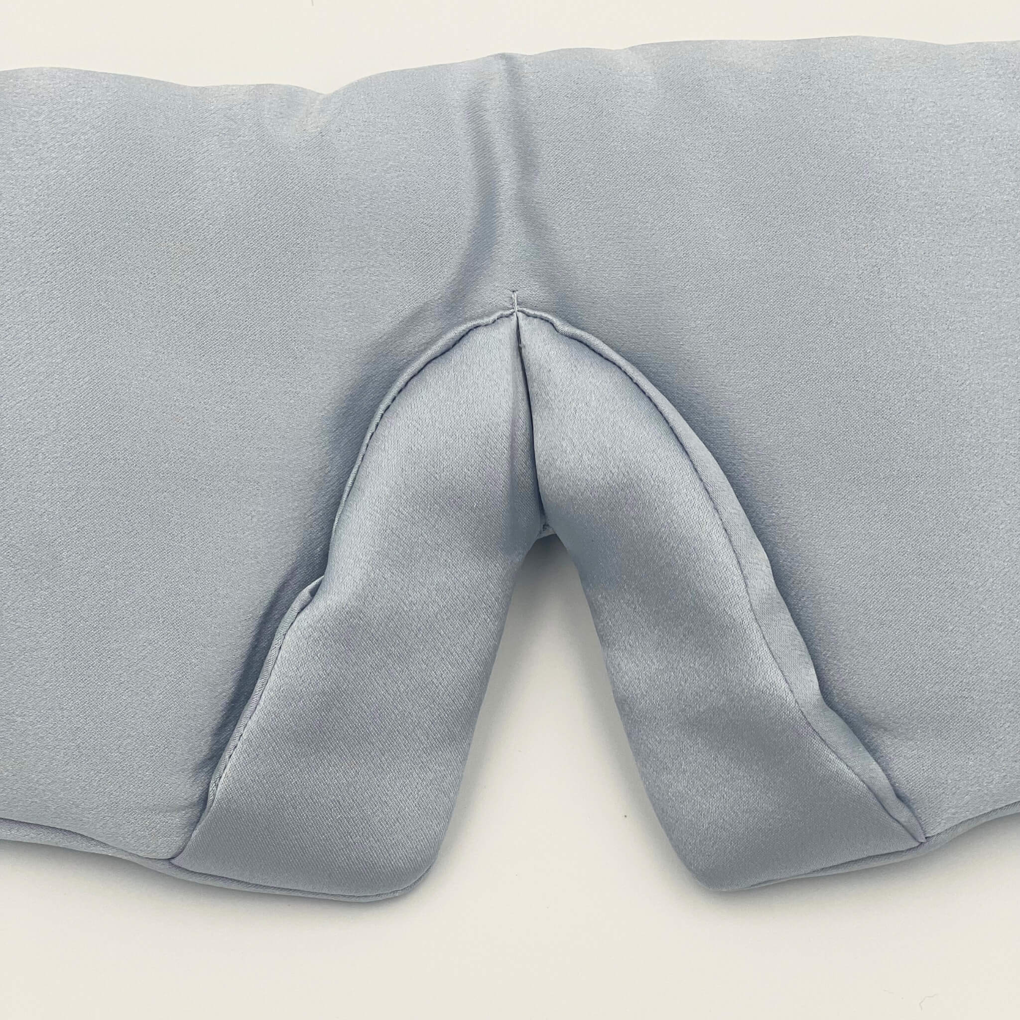 Close up of the padded nose area on a pale blue silk eye mask
