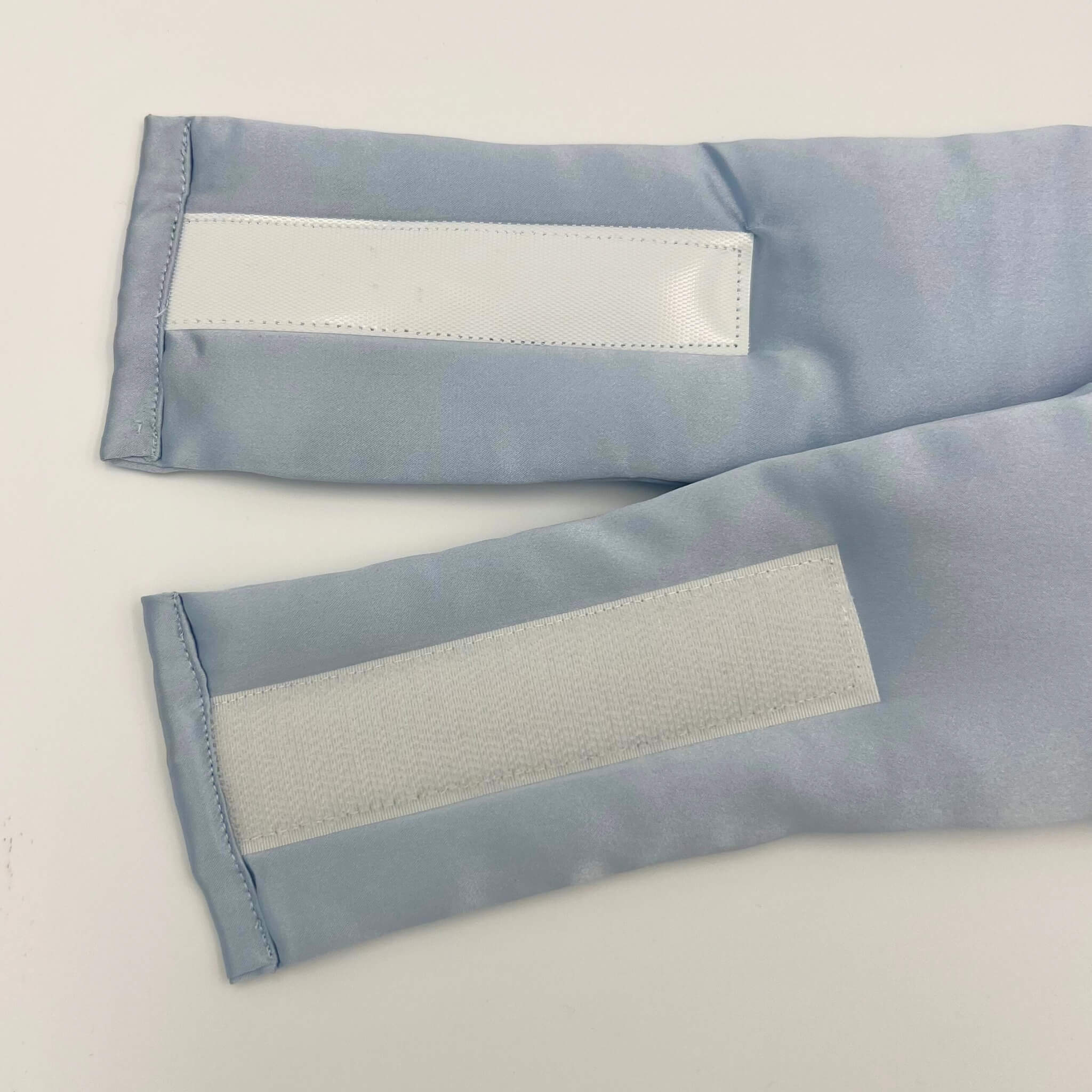 Close up of the velcro on a pale blue silk eye mask