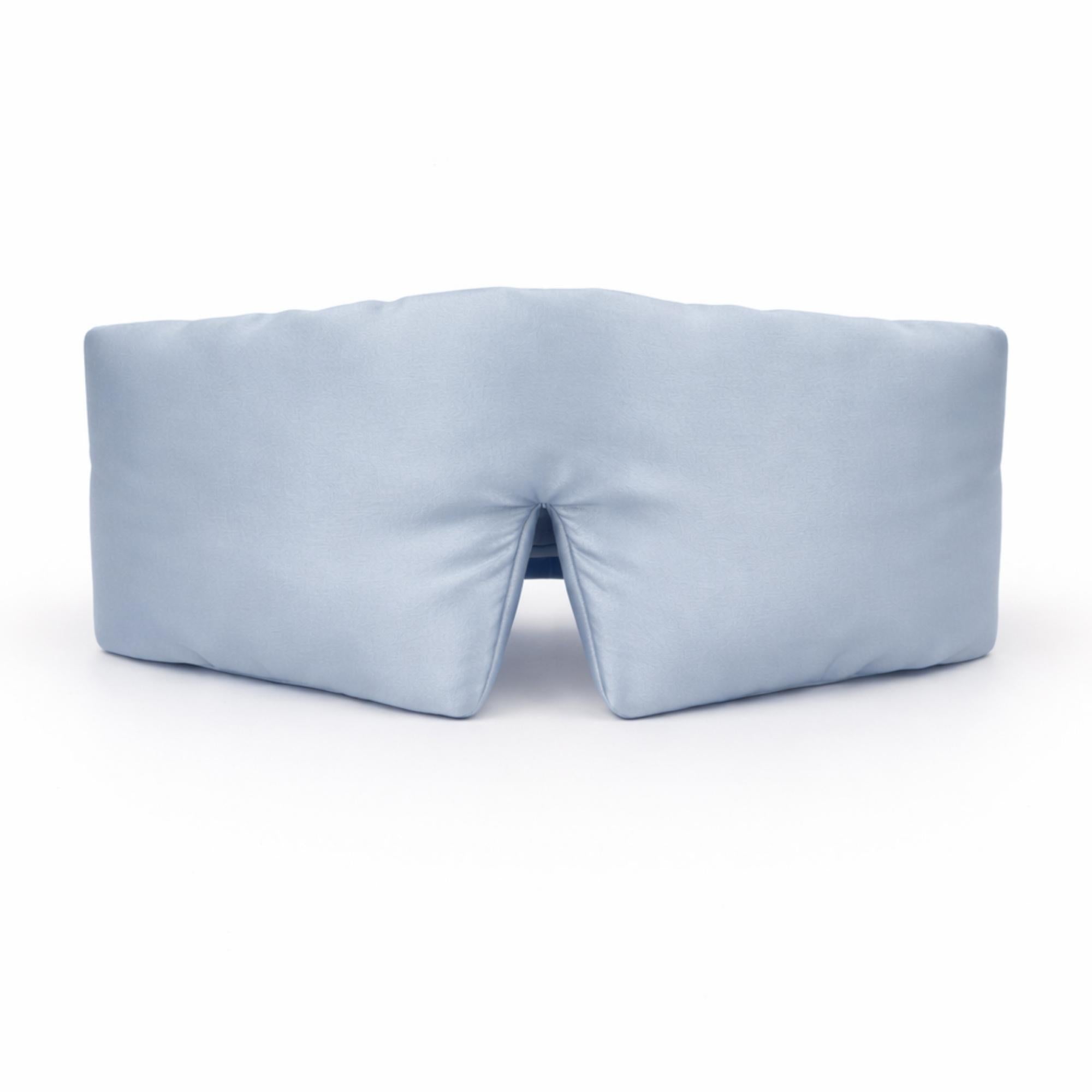 pale blue silk eye mask on a white background