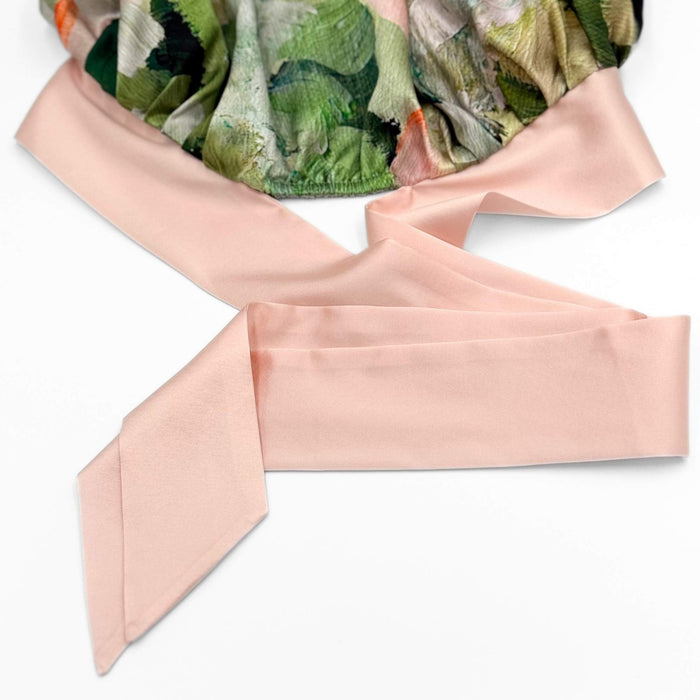 close up of the elasticated rear and adjustable ties of the silk tie bonnet