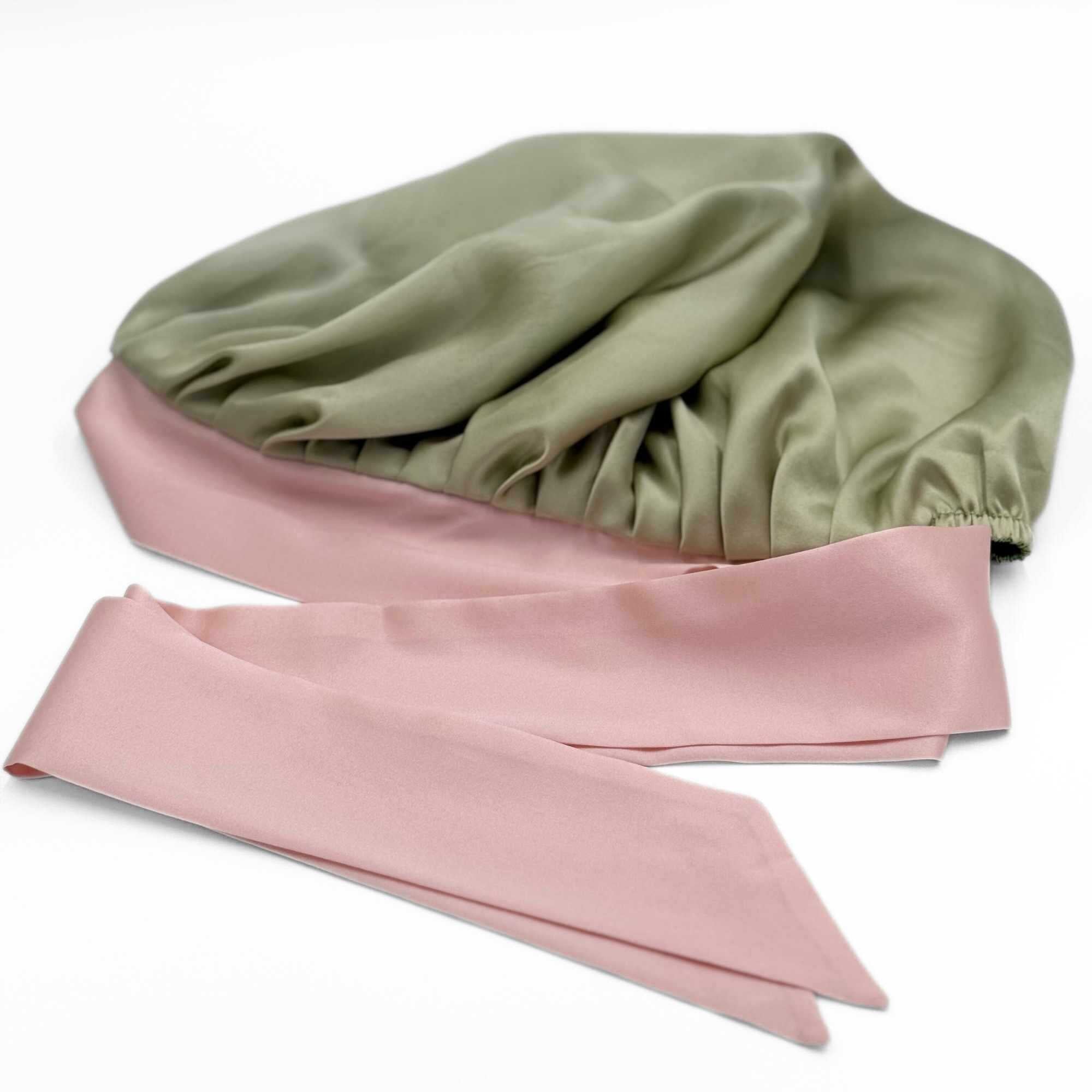 a flat lay of the plain green side of the reversible tie-able silk bonnet