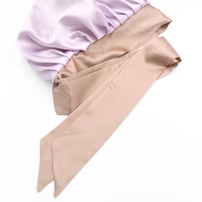 Close up of the adjustable ties of a silk bonnet